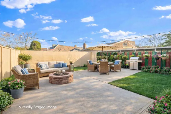 a view of a patio with couches and a fire pit
