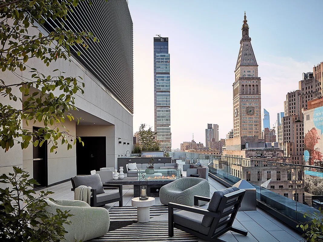 121 East 22nd Street, Unit N1405 Manhattan, NY 10010 - Photo 14 of 19 a living room with furniture and a fireplace