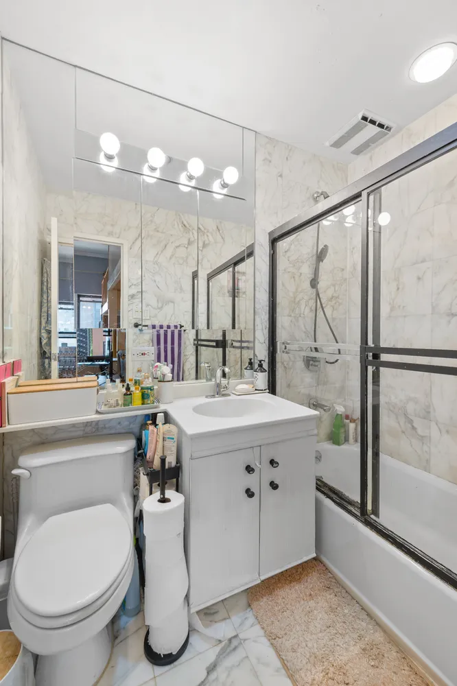 a bathroom with a sink a toilet and a mirror