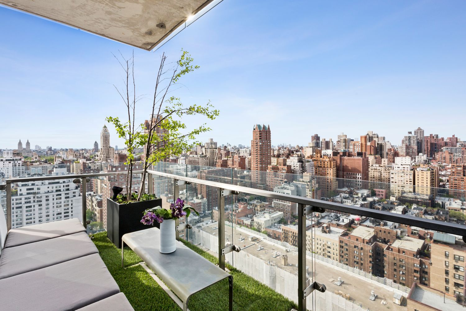 255 East 74th Street, Unit 20C Manhattan, NY 10021 - Photo 3 of 16 a view of a balcony with wooden benches