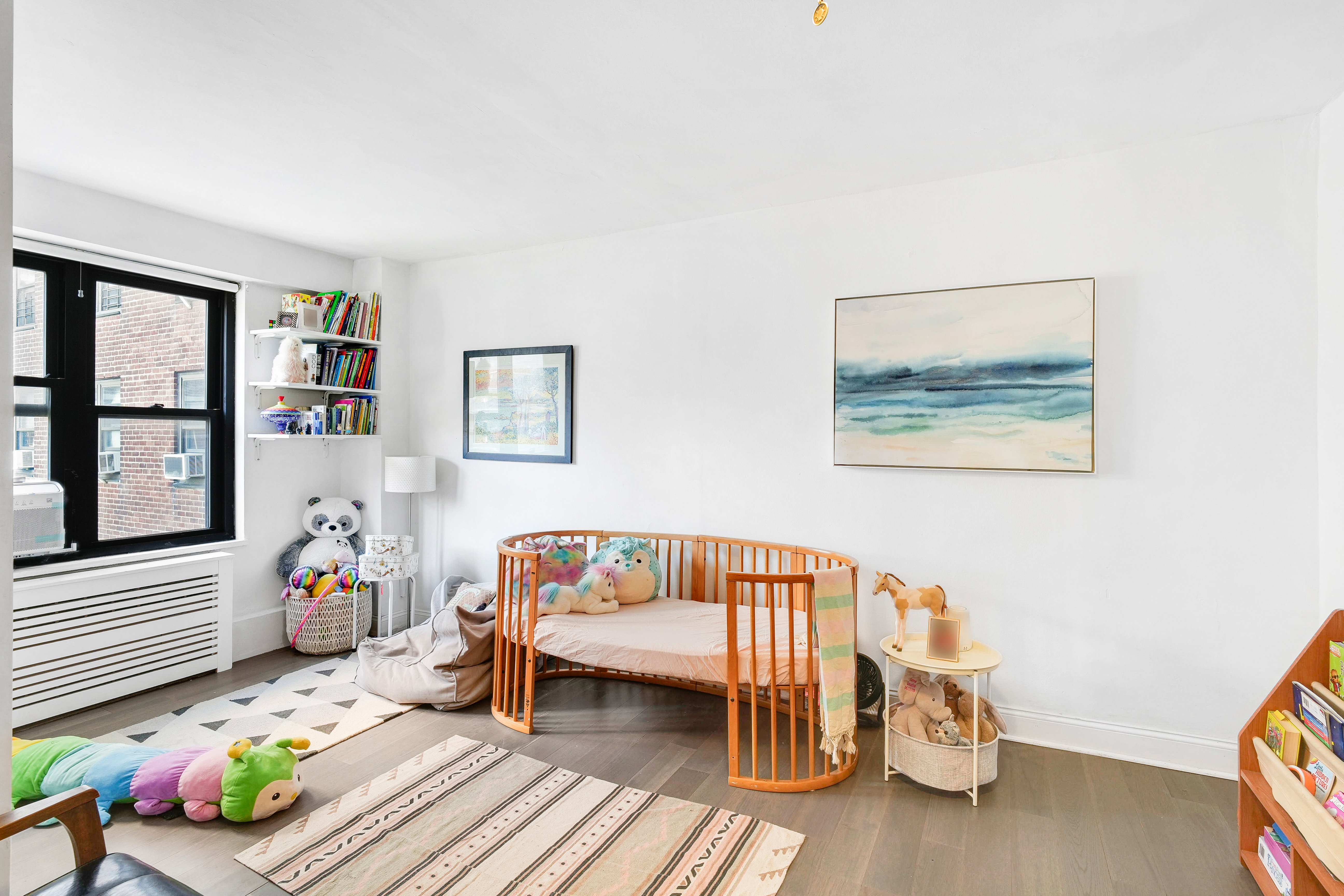 208 East Broadway, Unit J1304 Manhattan, NY 10002 - Photo 8 of 19 a bedroom with furniture and a wooden floor