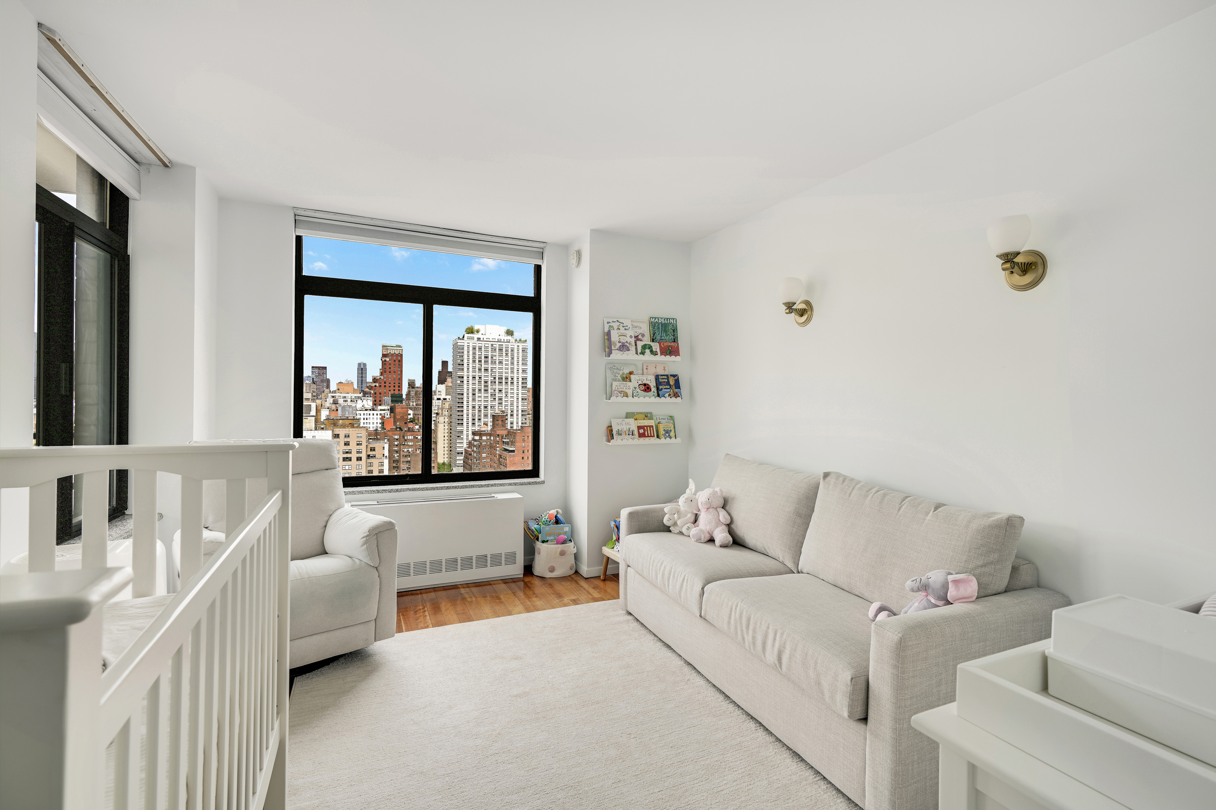 400 East 70th Street, Unit 2402 Manhattan, NY 10021 - Photo 10 of 18 a living room with furniture and a large window