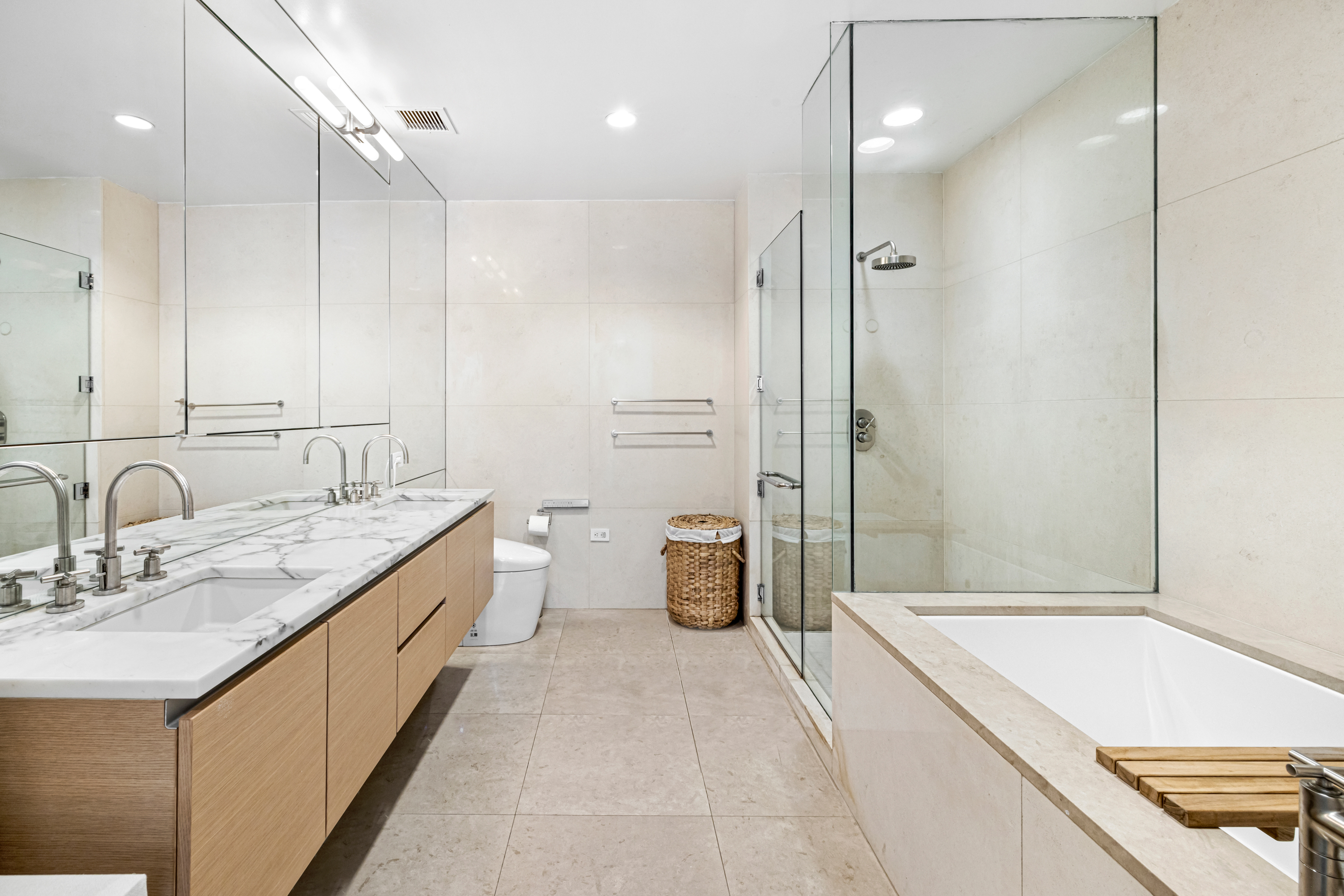 51 Walker Street, Unit 6B Manhattan, NY 10013 - Photo 8 of 10 a bathroom with a granite countertop sink mirror and shower