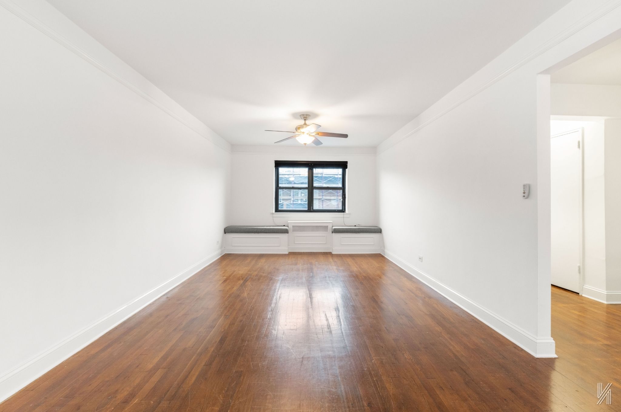 34-10 94th Street, Unit 6G Queens, NY 11372 - Photo 14 of 19 an empty room with wooden floor and windows