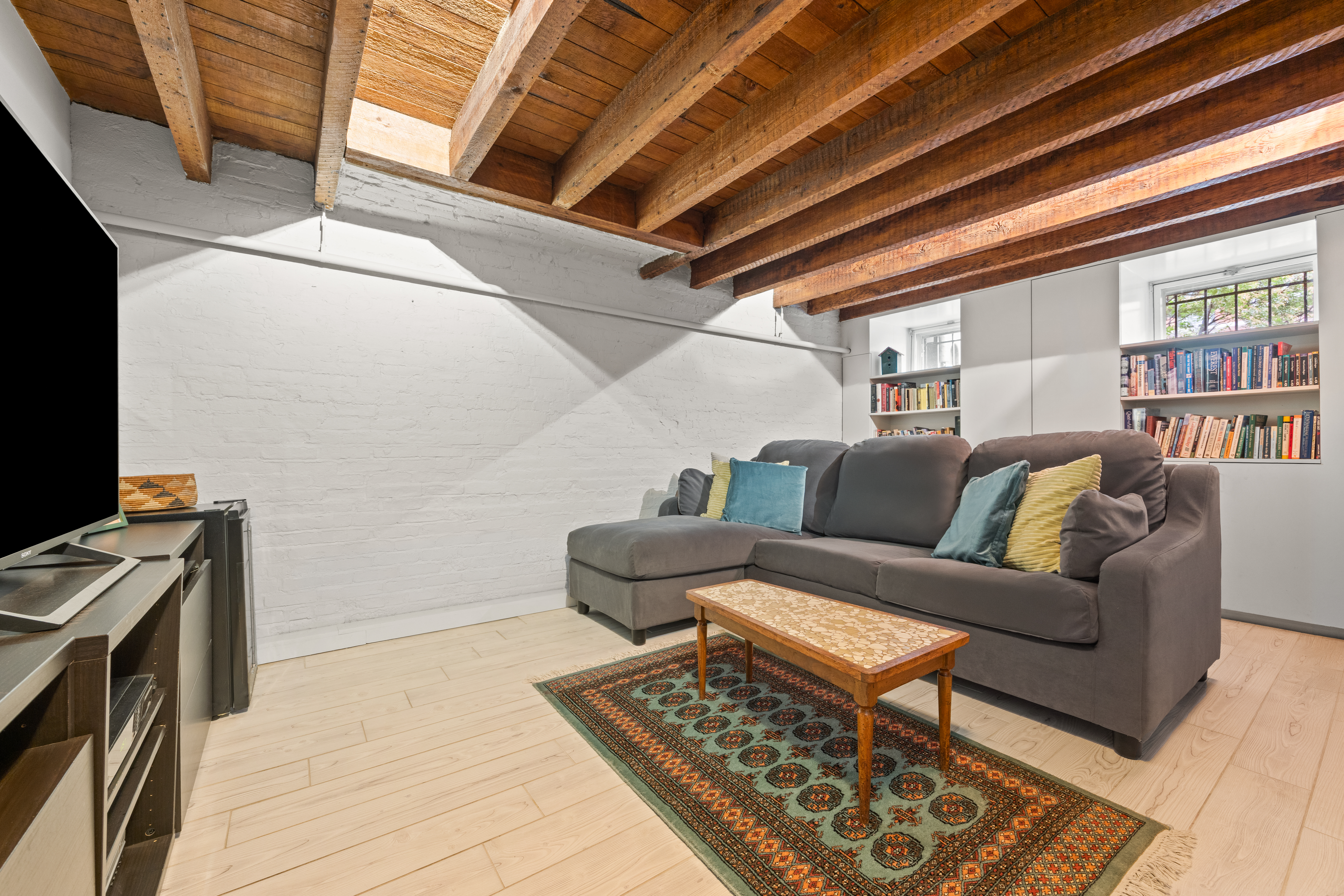 482 11th Street Brooklyn, NY 11215 - Photo 19 of 24 a living room with furniture and a flat screen tv