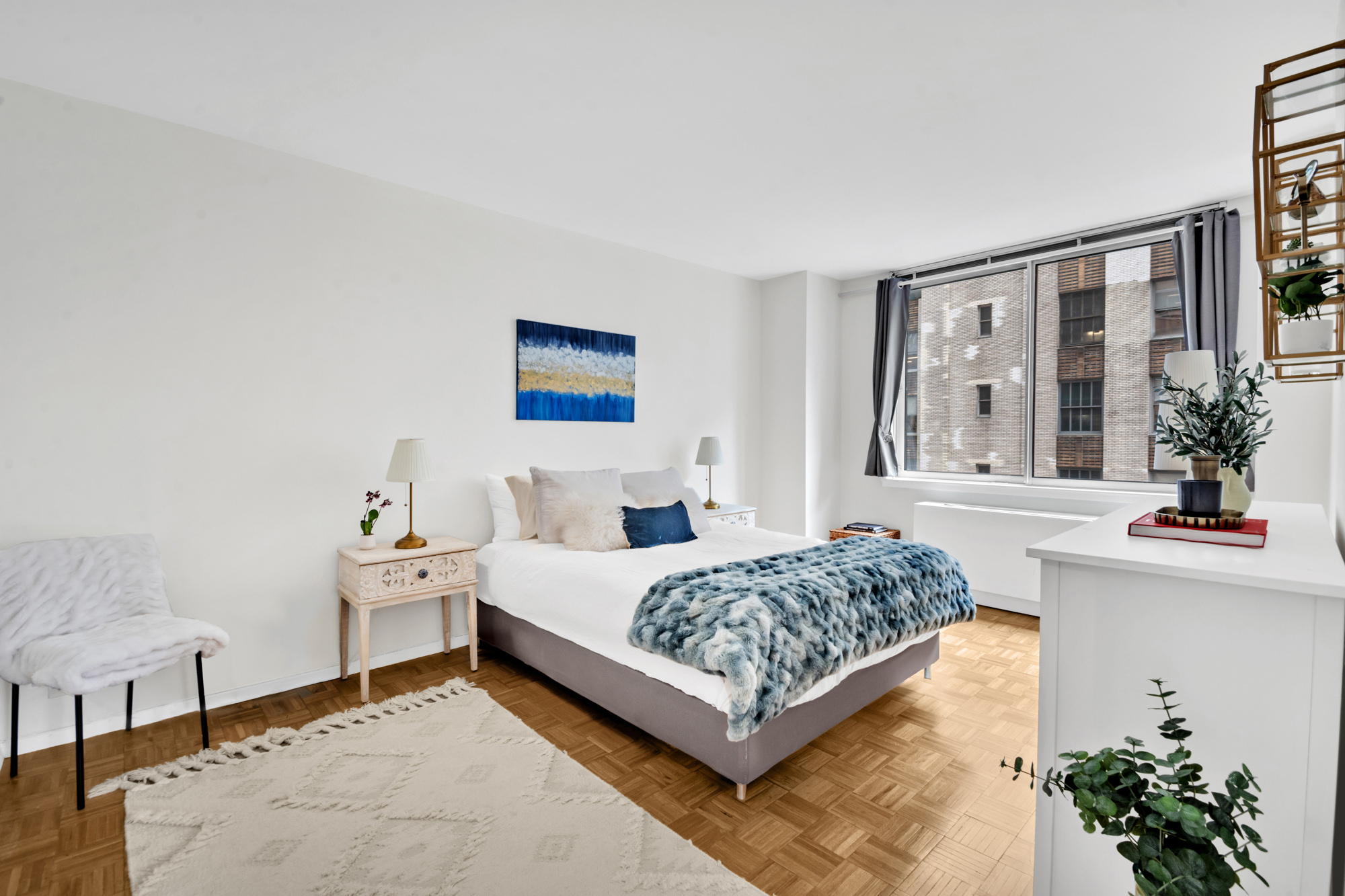 235 East 40th Street, Unit 11G Manhattan, NY 10016 - Photo 6 of 20 a bedroom with a bed and a potted plant