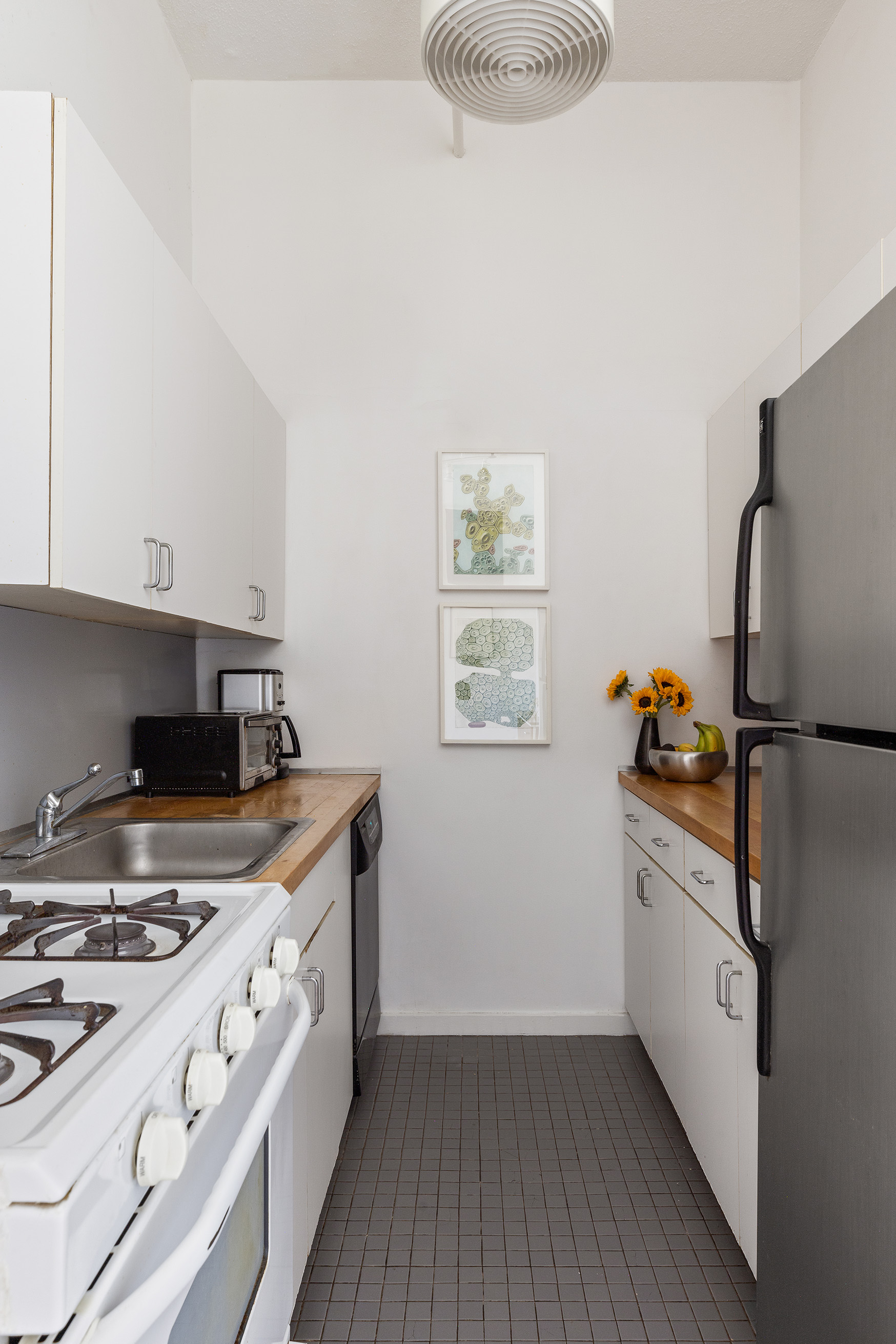 120 Boerum Place, Unit 2E Brooklyn, NY 11201 - Photo 8 of 13 a kitchen with stainless steel appliances granite countertop a stove and a refrigerator