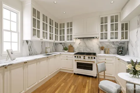 a kitchen with cabinets appliances and wooden floor