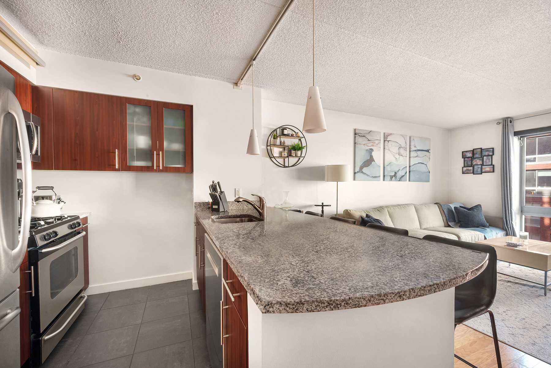555 West 23rd Street, Unit S11C Manhattan, NY 10011 - Photo 2 of 12 a kitchen with granite countertop a sink a counter top space and stainless steel appliances