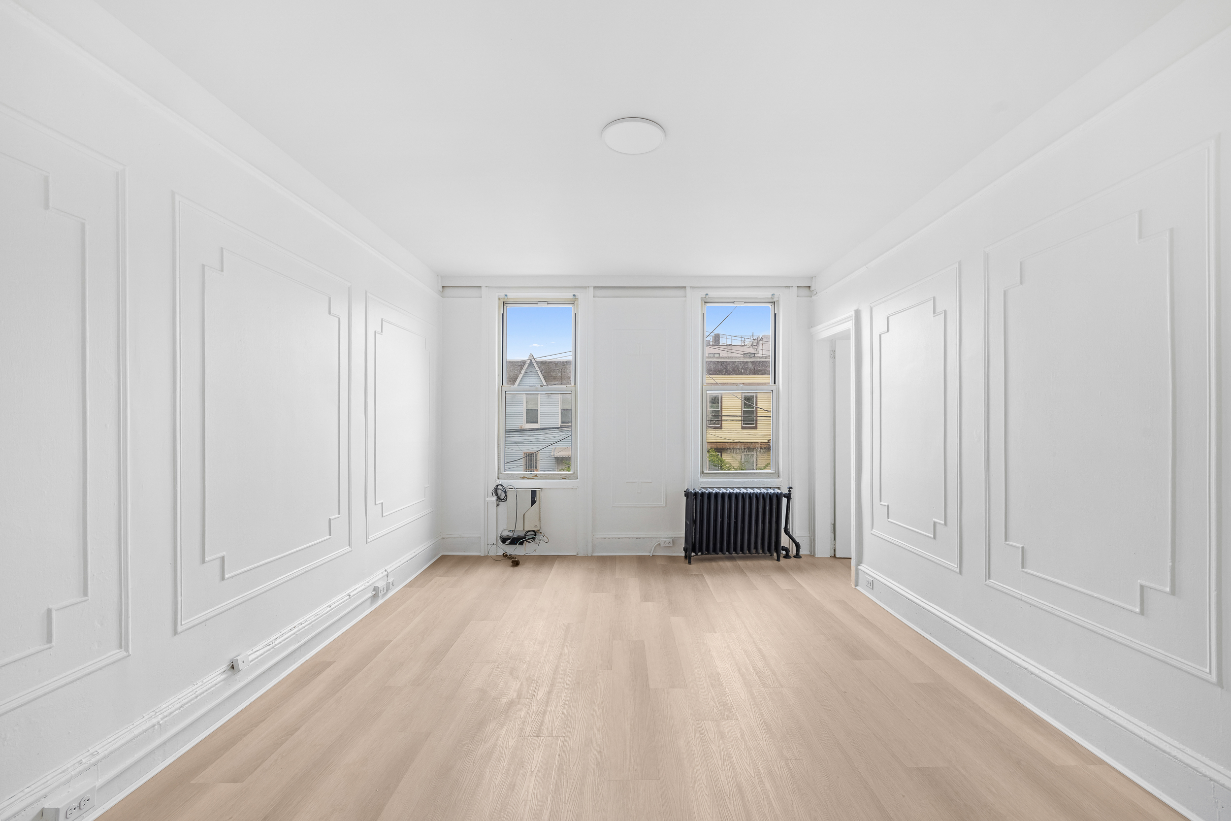 996 Hart Street, Unit 2 Brooklyn, NY 11237 - Photo 2 of 7 an empty room with windows