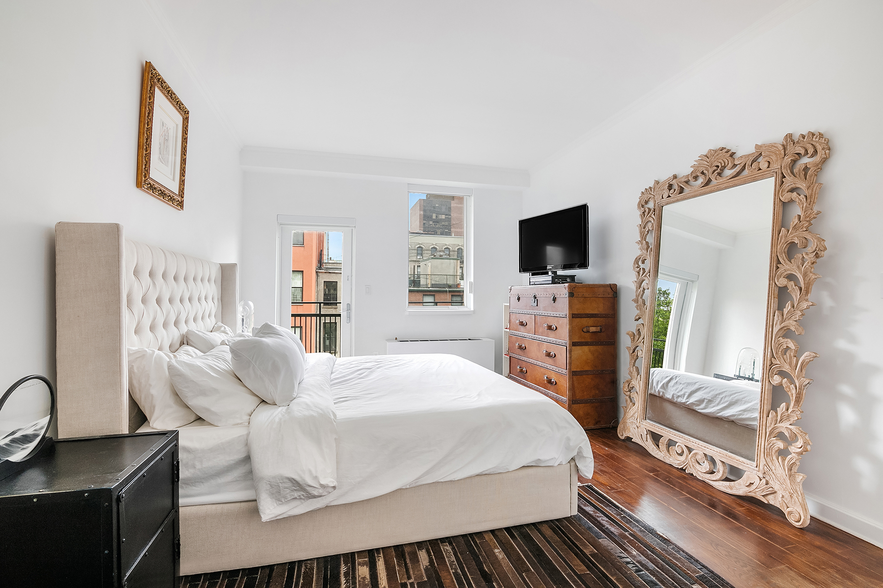 32 West 128th Street, Unit 4 Manhattan, NY 10027 - Photo 6 of 11 a bedroom with a bed and a flat screen tv
