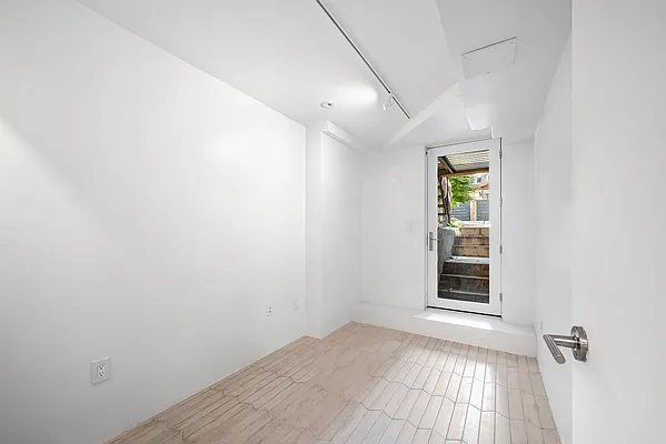 164 Sterling Street, Unit GARDEN Brooklyn, NY 11225 - Photo 4 of 5 a view of an empty room with a window