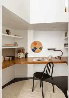 a cabinet with a table and white cabinet