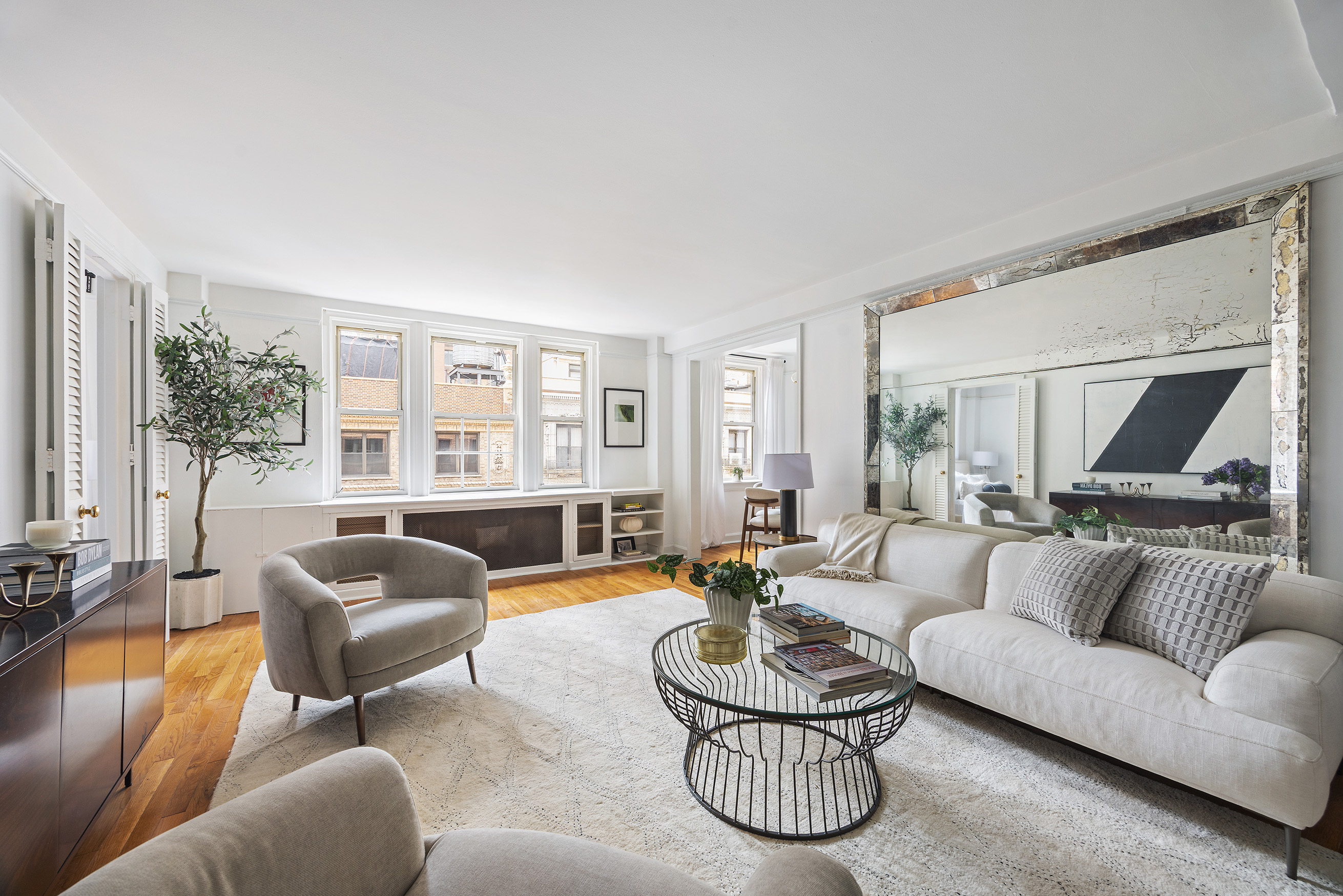 155 East 49th Street, Unit 10A Manhattan, NY 10017 - Photo 3 of 16 a living room with furniture and a large window
