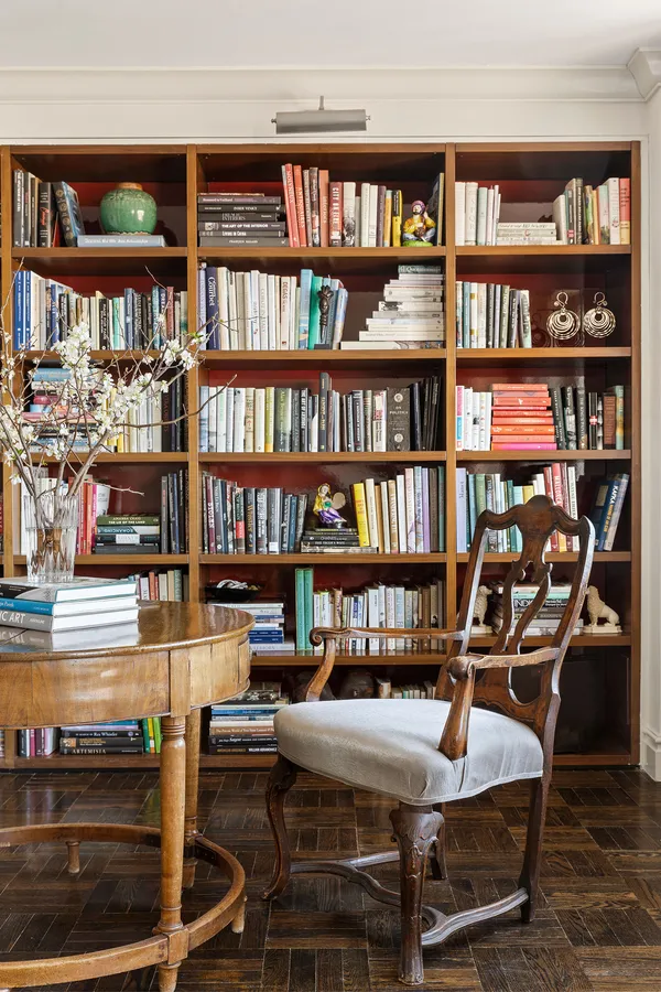 a view of a workspace with bookshelf