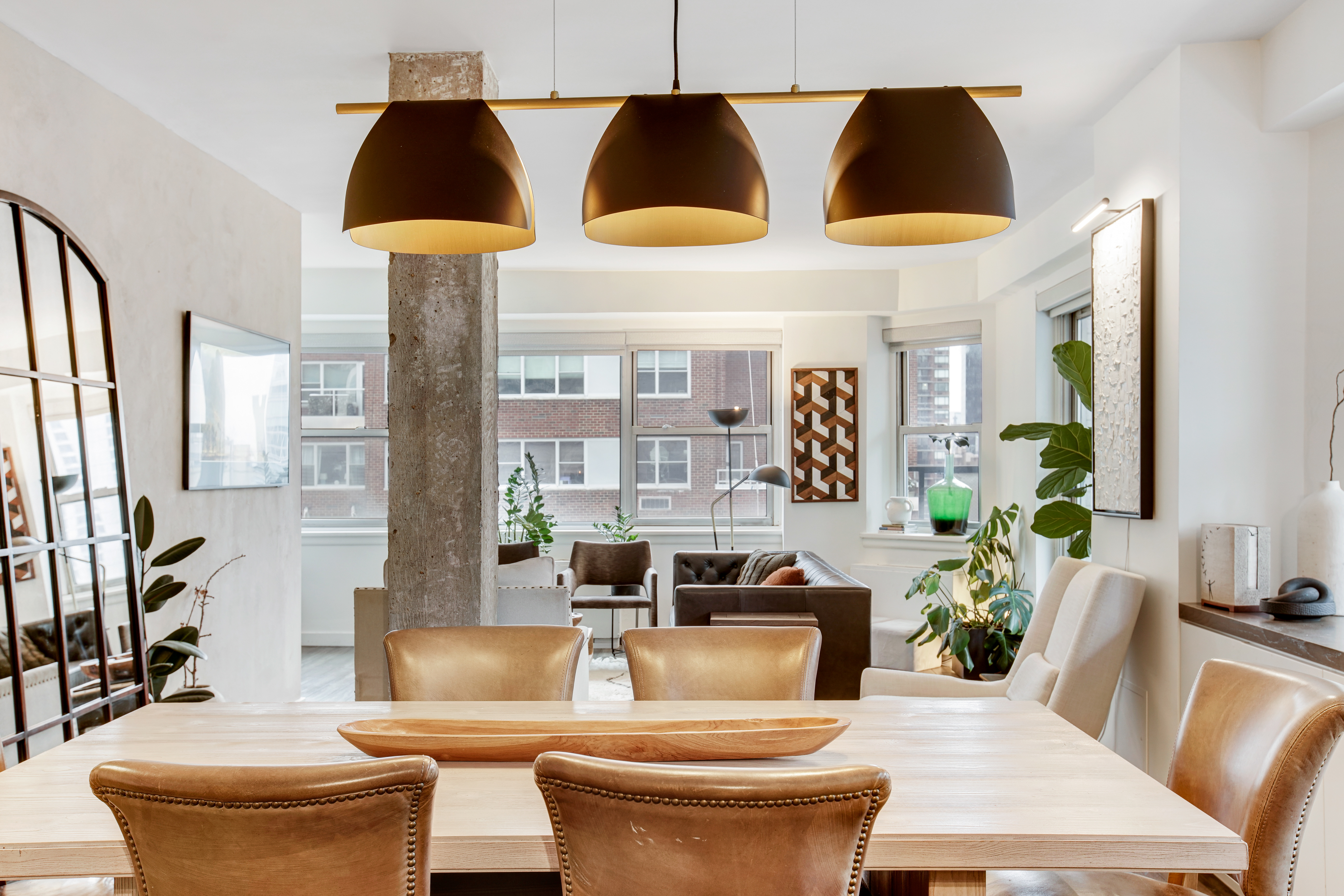 175 East 62nd Street, Unit 18B Manhattan, NY 10065 - Photo 6 of 17 a living room with furniture a flat screen tv and a large window