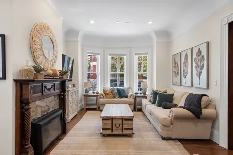 a living room with furniture and a fireplace