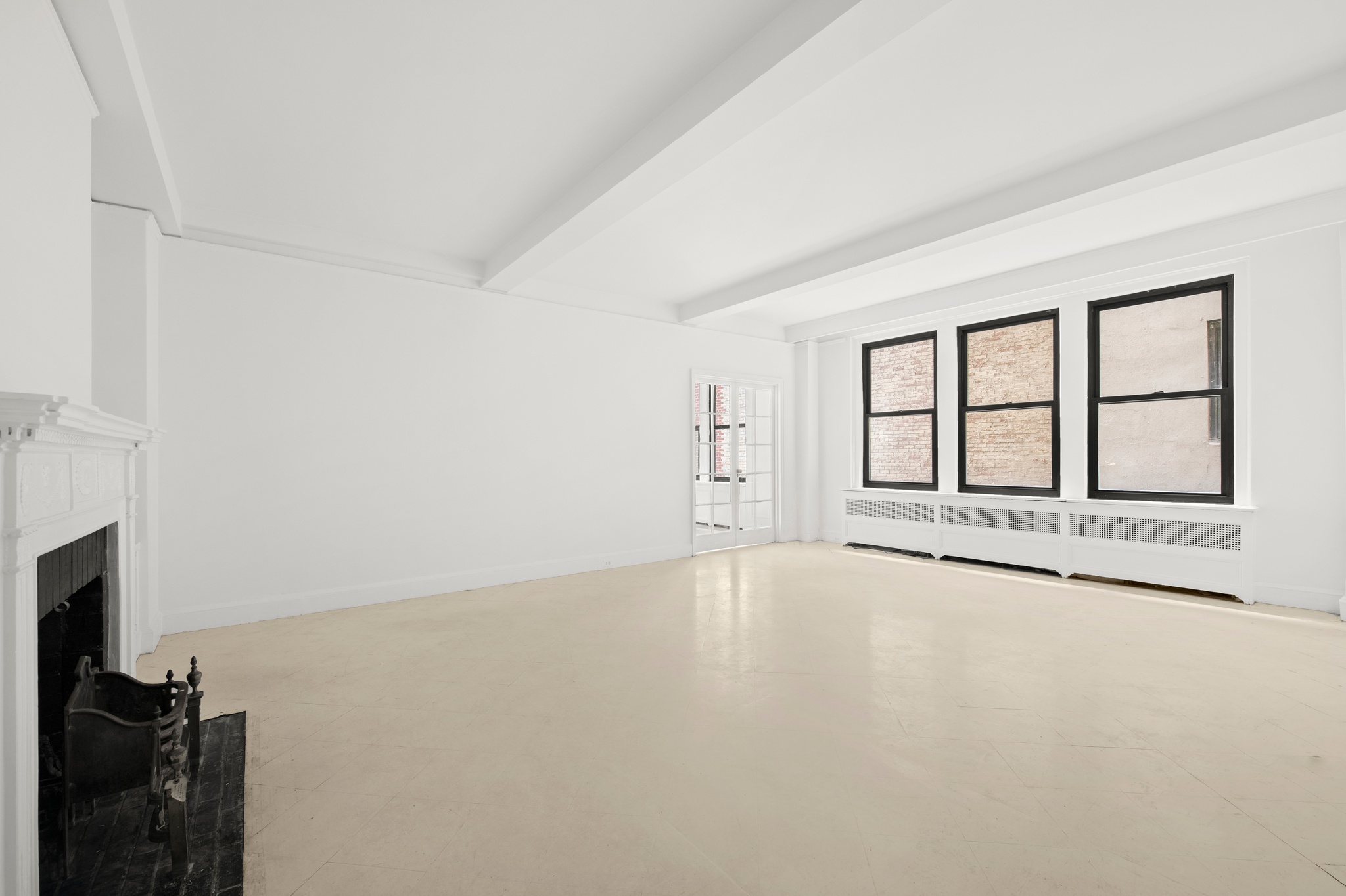 55 East 72nd Street, Unit 2NORTH Manhattan, NY 10021 - Photo 4 of 18 a view of an empty room with a fireplace and a window