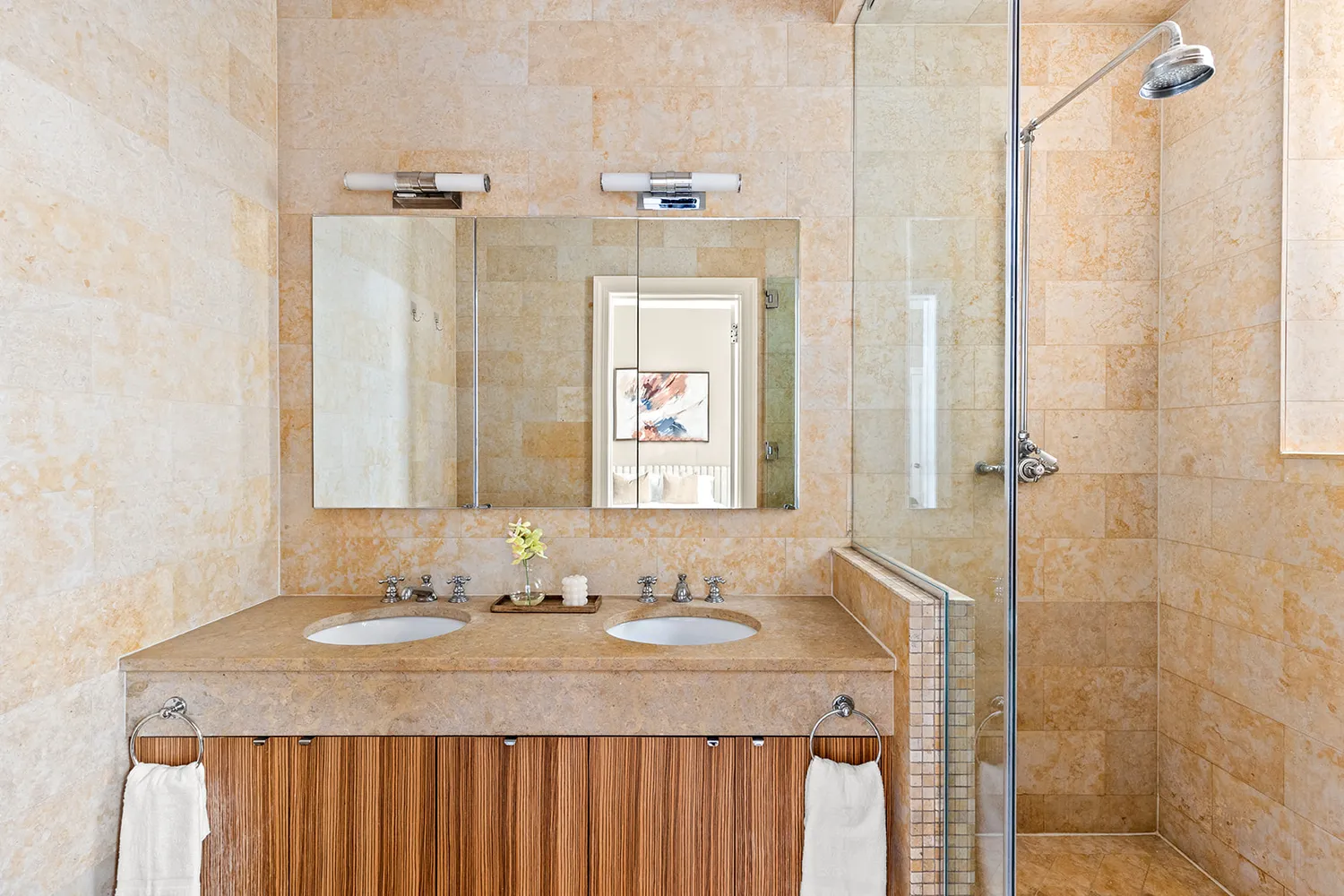 a bathroom with a granite countertop sink a mirror and a shower