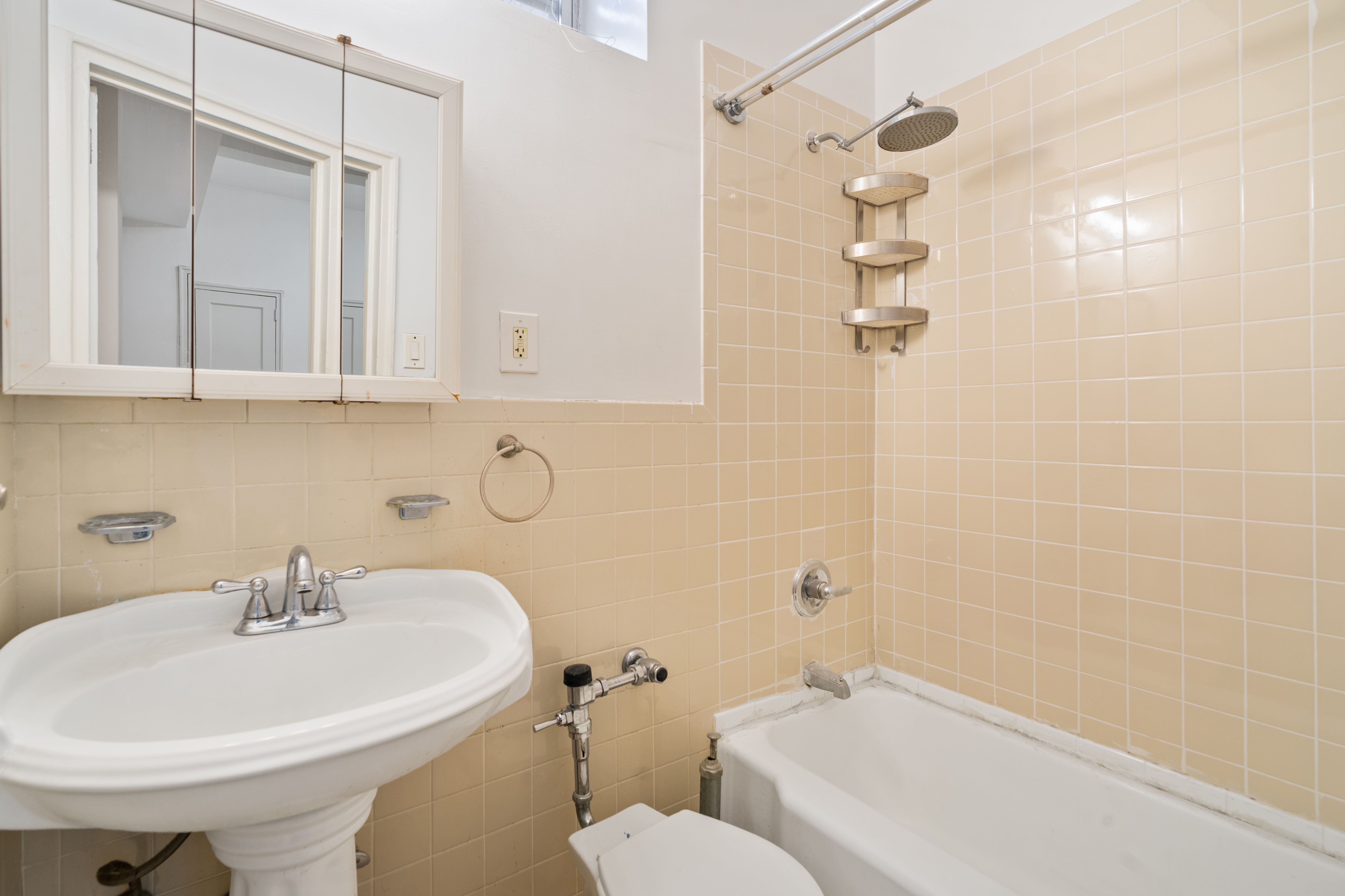 68-63 108th Street, Unit 1B Queens, NY 11375 - Photo 8 of 13 a bathroom with a sink a toilet and shower
