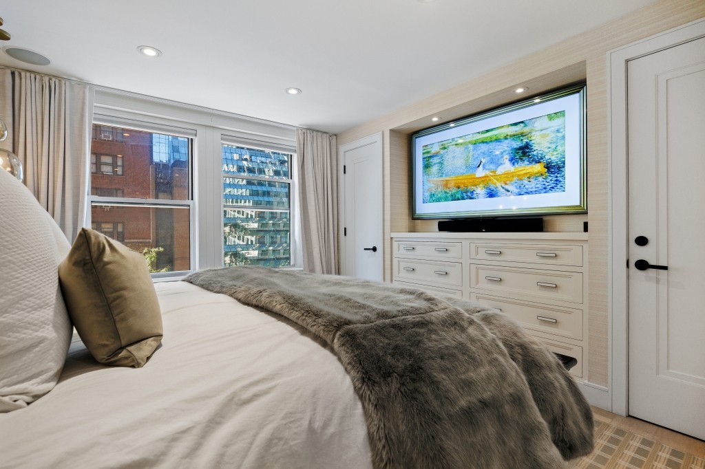 433 West 34th Street, Unit 4ABC Manhattan, NY 10001 - Photo 15 of 20 a bedroom with a bed and flat screen tv