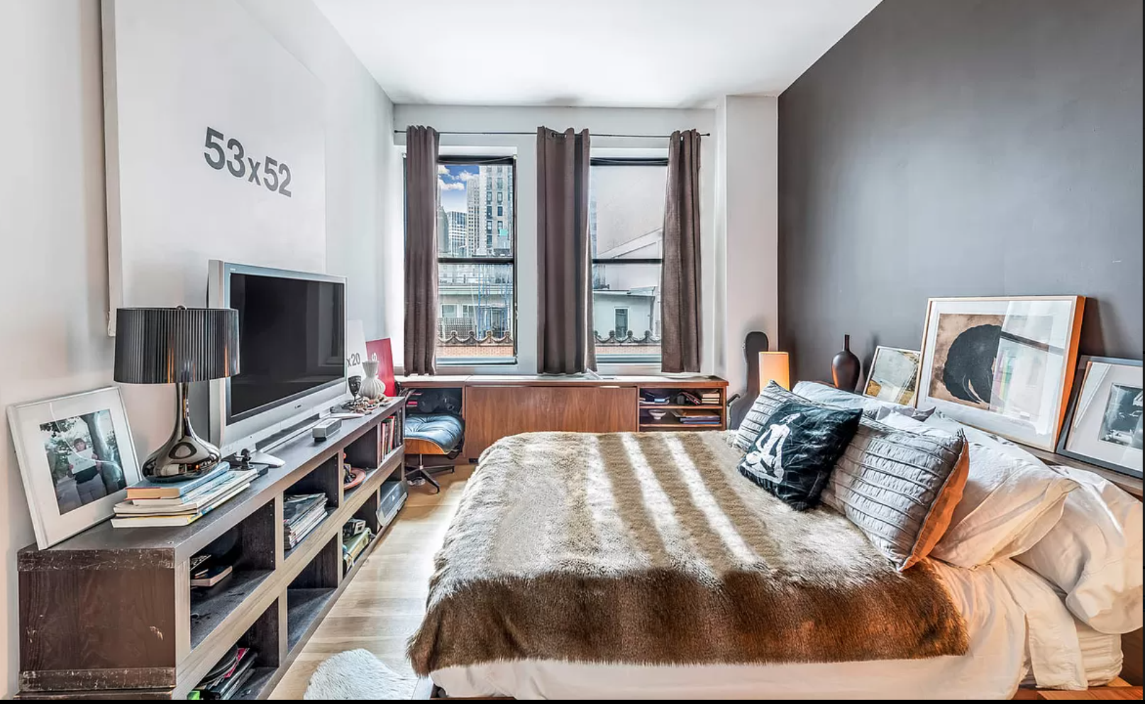 71 Nassau Street, Unit 12C Manhattan, NY 10038 - Photo 9 of 18 a bedroom with a bed and a flat screen tv