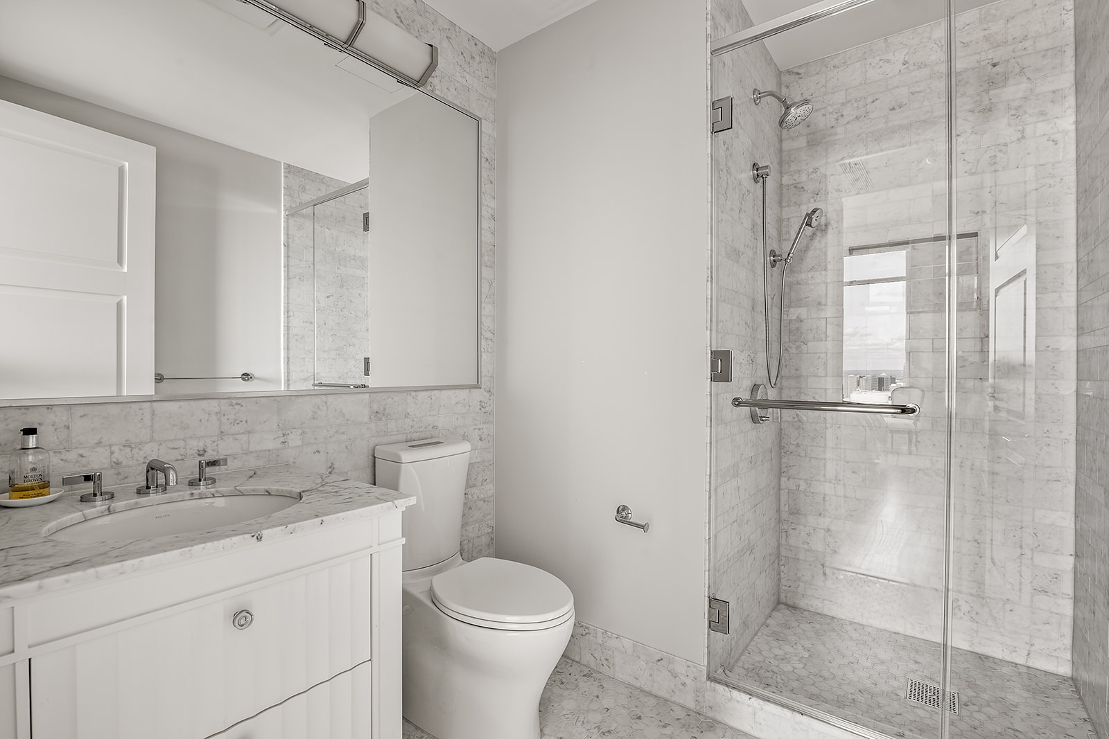 30 Park Place, Unit 43A Manhattan, NY 10007 - Photo 9 of 13 a bathroom with a granite countertop sink toilet and shower