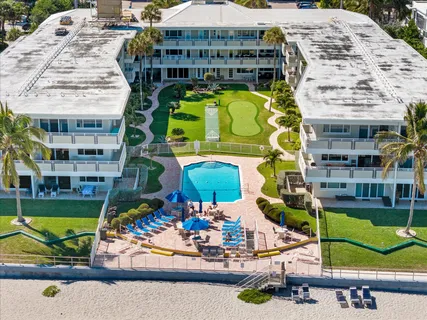 an aerial view of multi story residential apartment building with yard