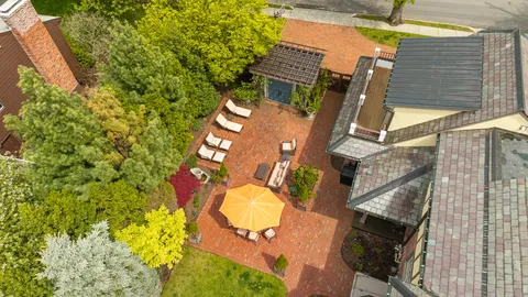 a aerial view of a house with swimming pool and wooden fence