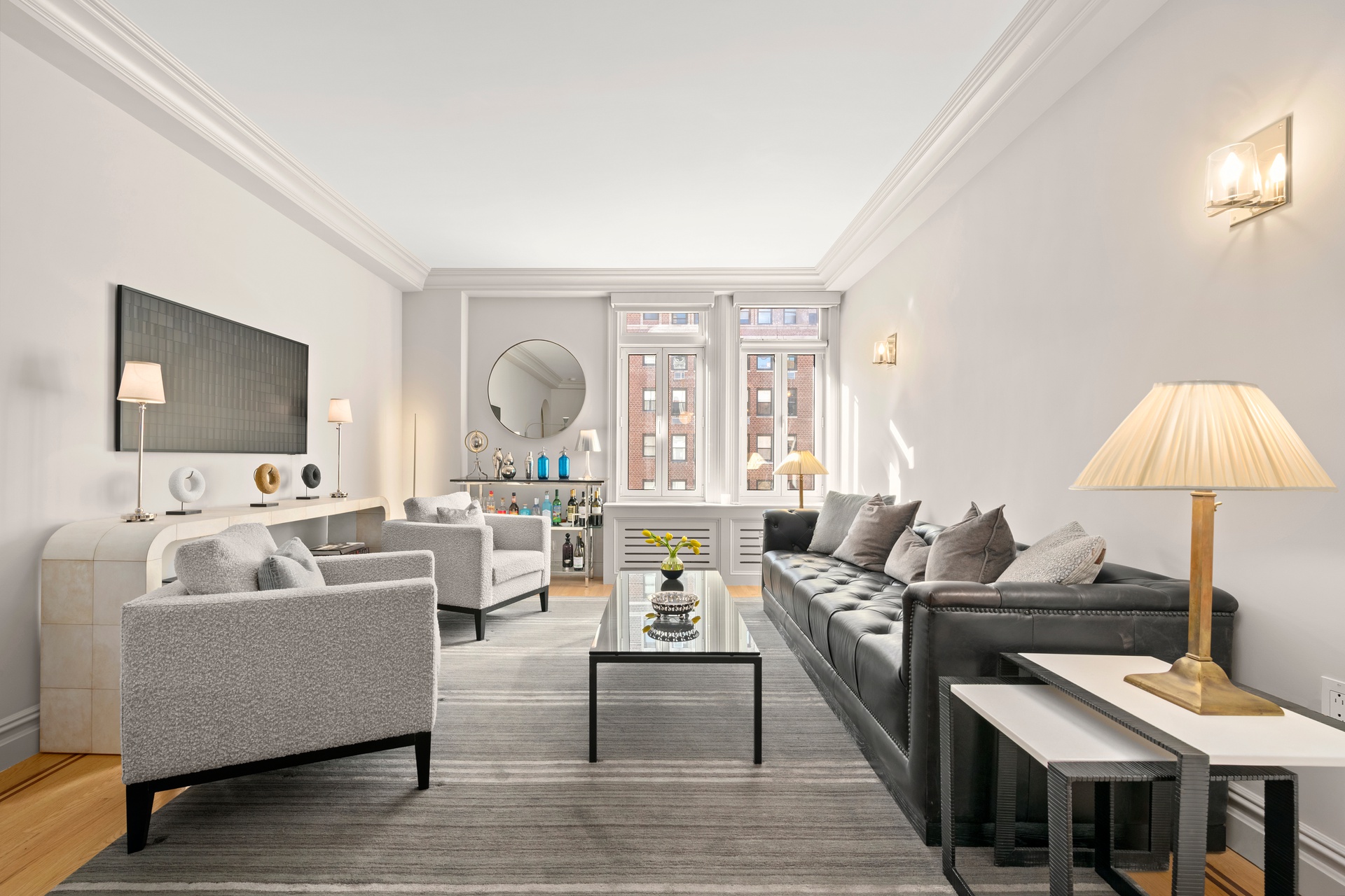 305 West 72nd Street, Unit 10A Manhattan, NY 10023 - Photo 1 of 12 a living room with furniture and a flat screen tv