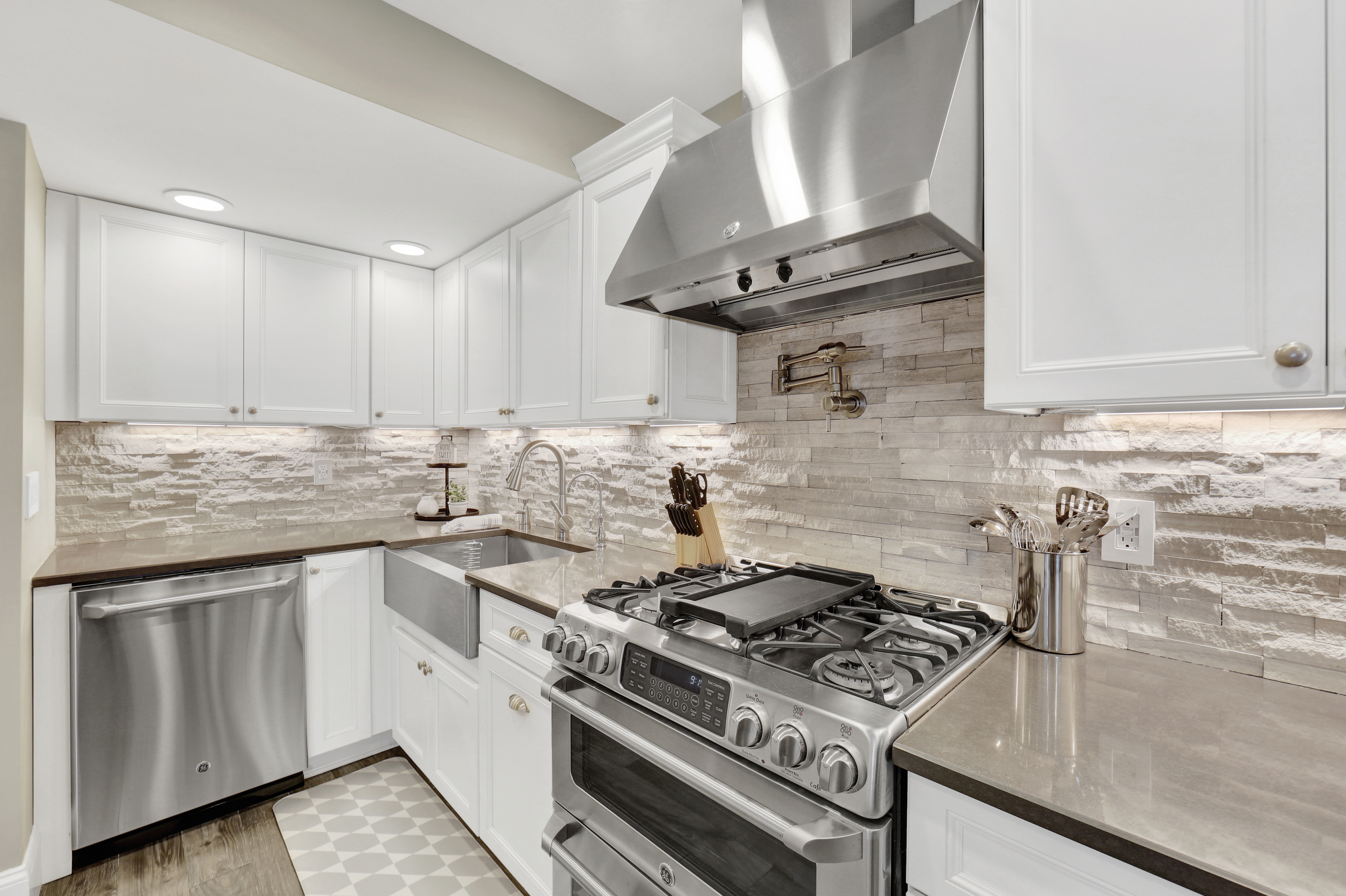 1-69 Beach 98th Street, Unit 1 Queens, NY 11694 - Photo 8 of 23 a kitchen with granite countertop a stove and a sink