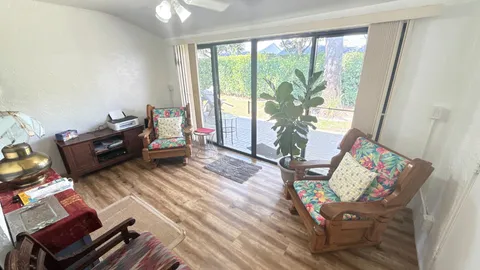 a living room with furniture and a floor to ceiling window
