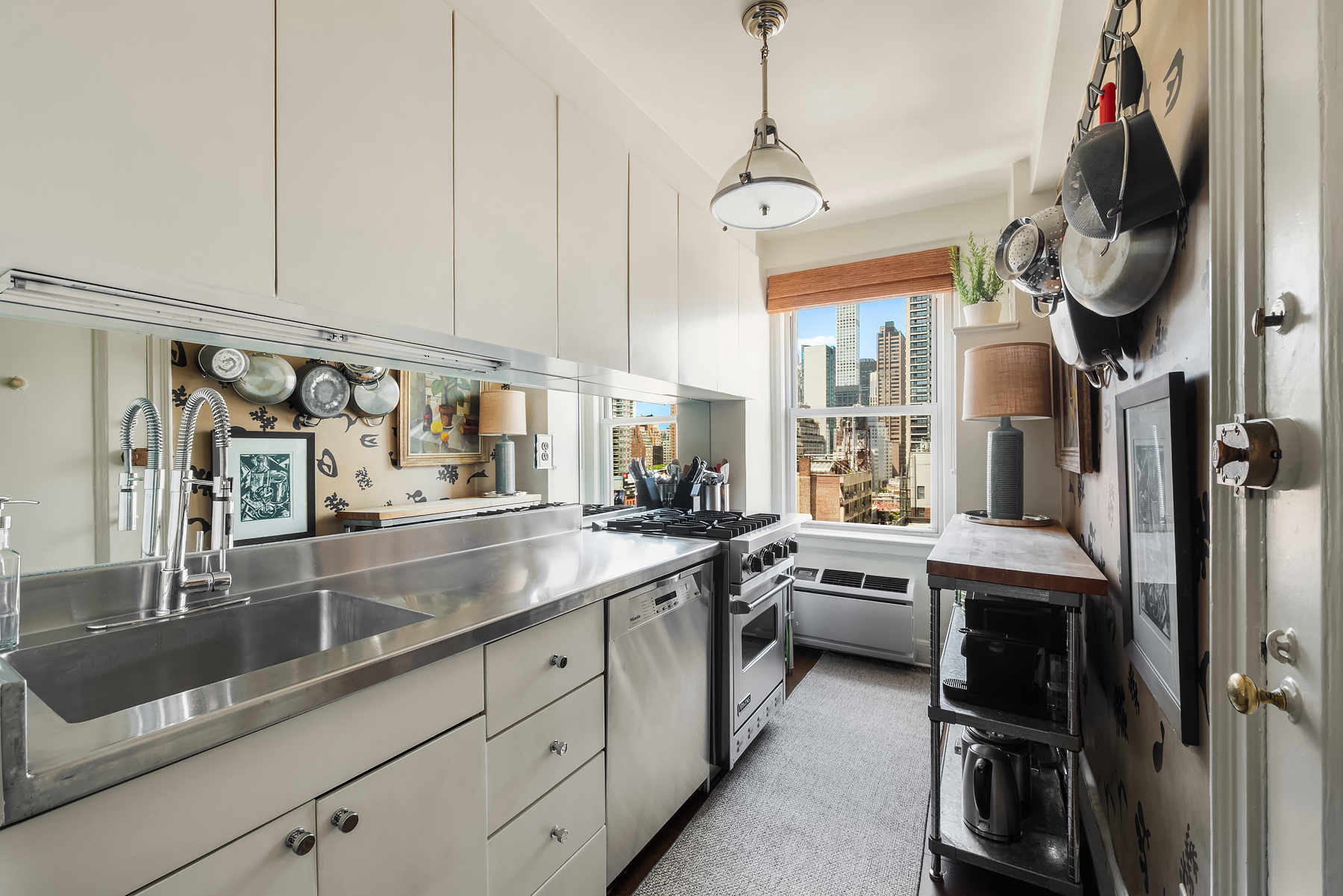 400 East 59th Street, Unit 13B Manhattan, NY 10022 - Photo 4 of 7 a kitchen with stainless steel appliances granite countertop a sink and cabinets