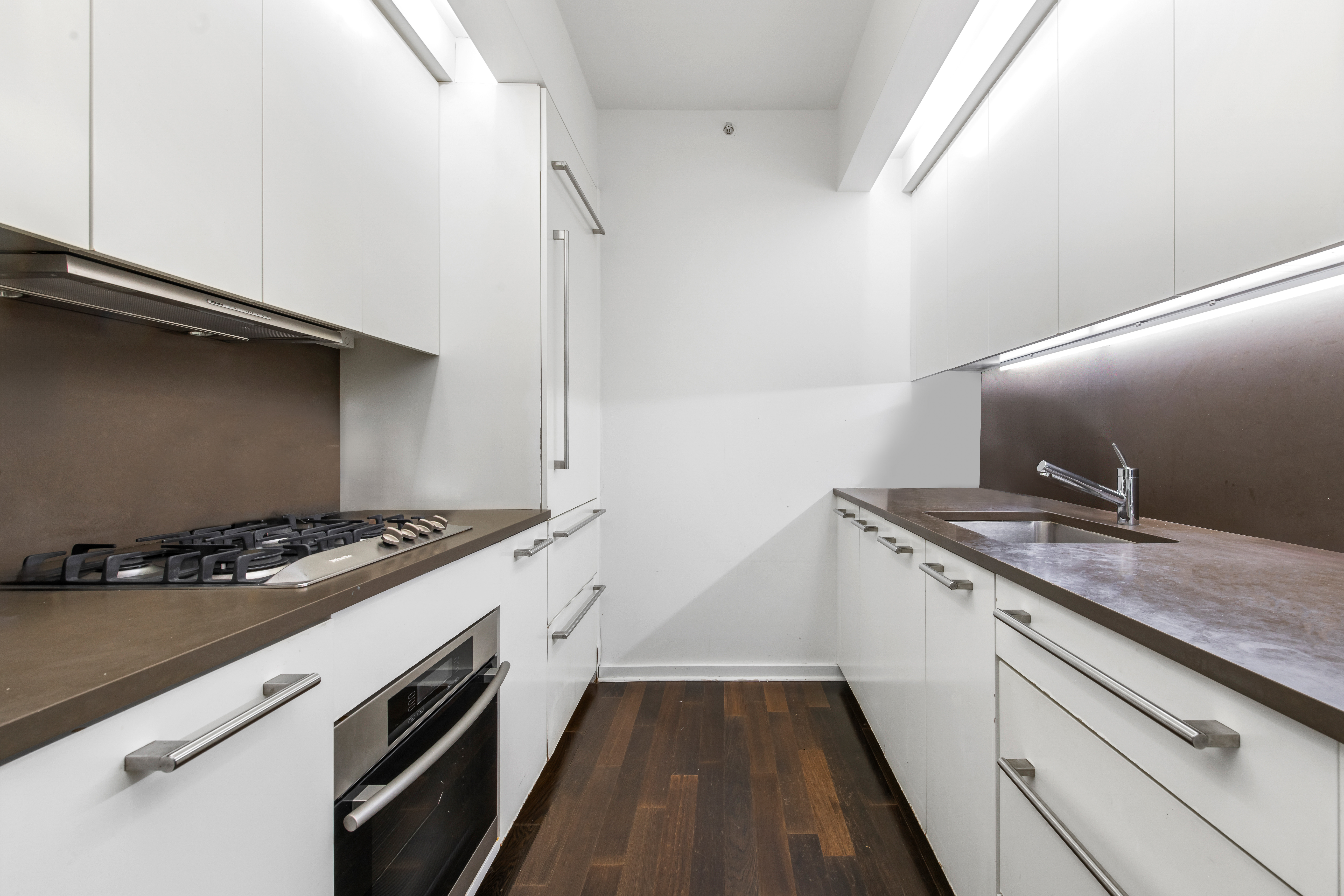 340 East 23rd Street, Unit 4D Manhattan, NY 10010 - Photo 3 of 19 a kitchen with a stove and a wooden floor