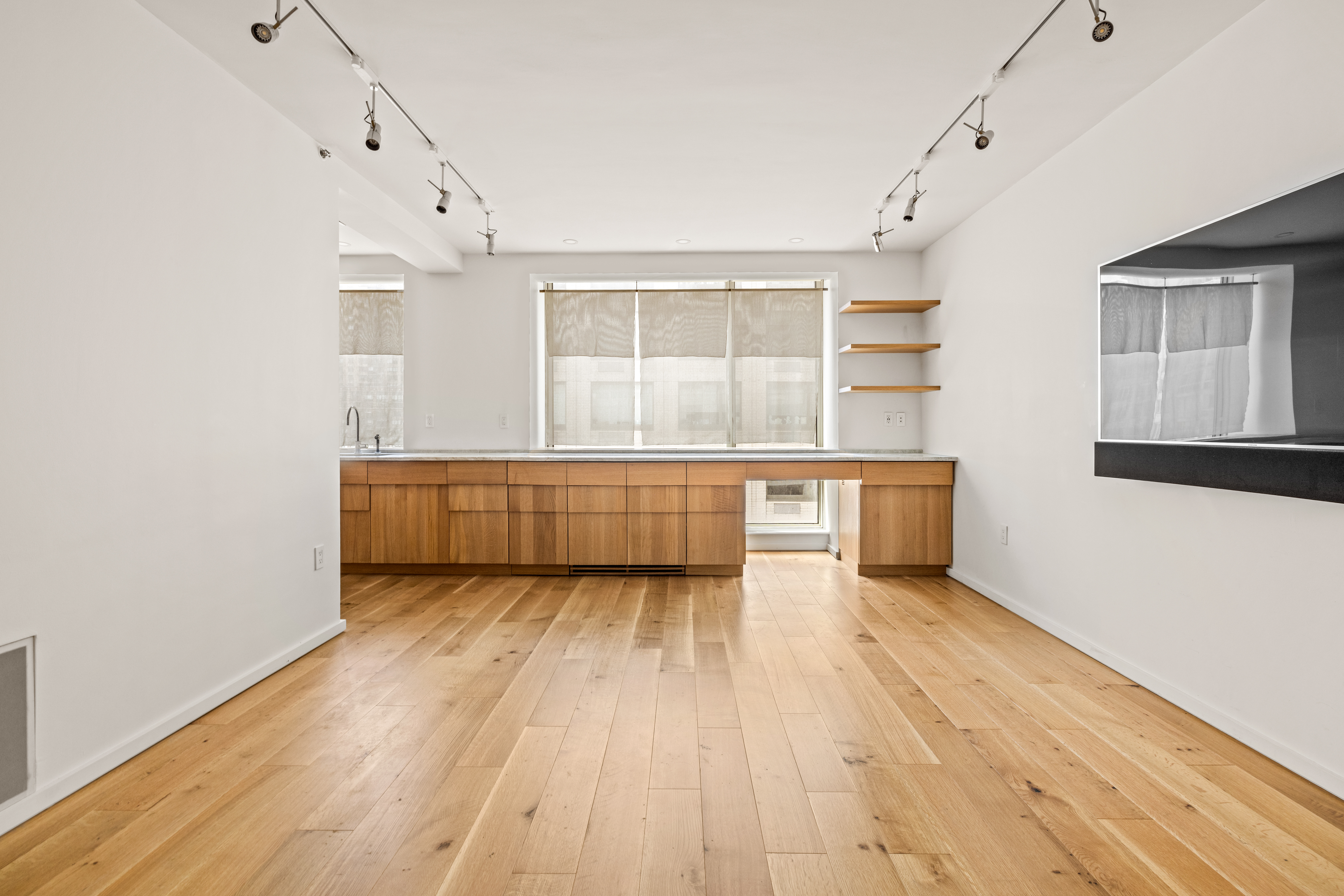 120 Riverside Boulevard, Unit 10W Manhattan, NY 10069 - Photo 2 of 14 an empty room with wooden floor and windows