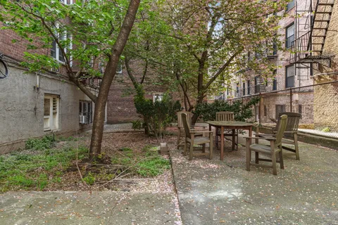 a view of a chairs and table in backyard