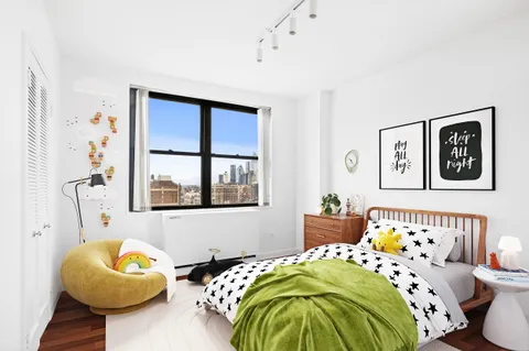 a bedroom with bed and a window