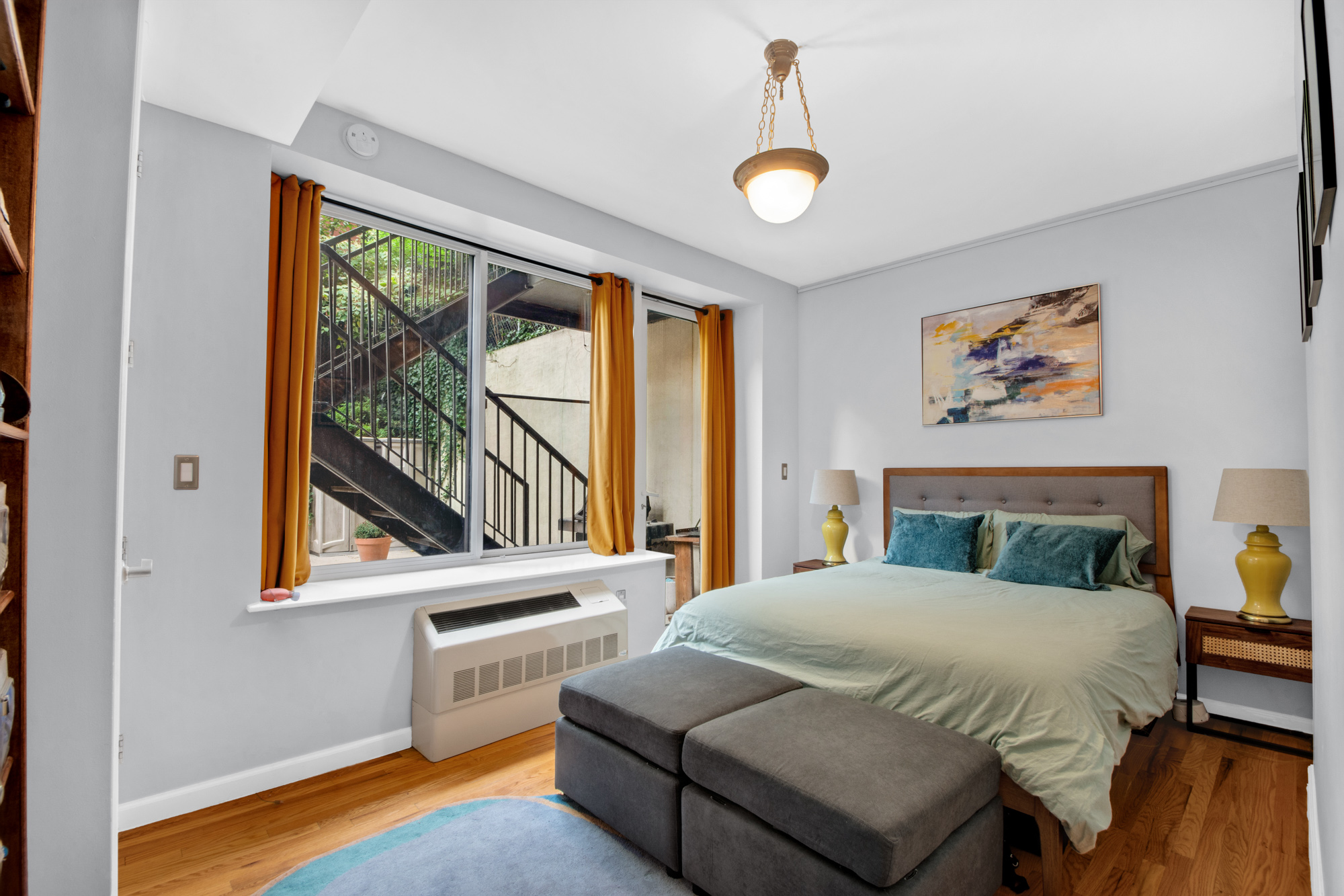 5 West 127th Street, Unit 1B Manhattan, NY 10027 - Photo 6 of 11 a bedroom with a bed and a painting on the wall