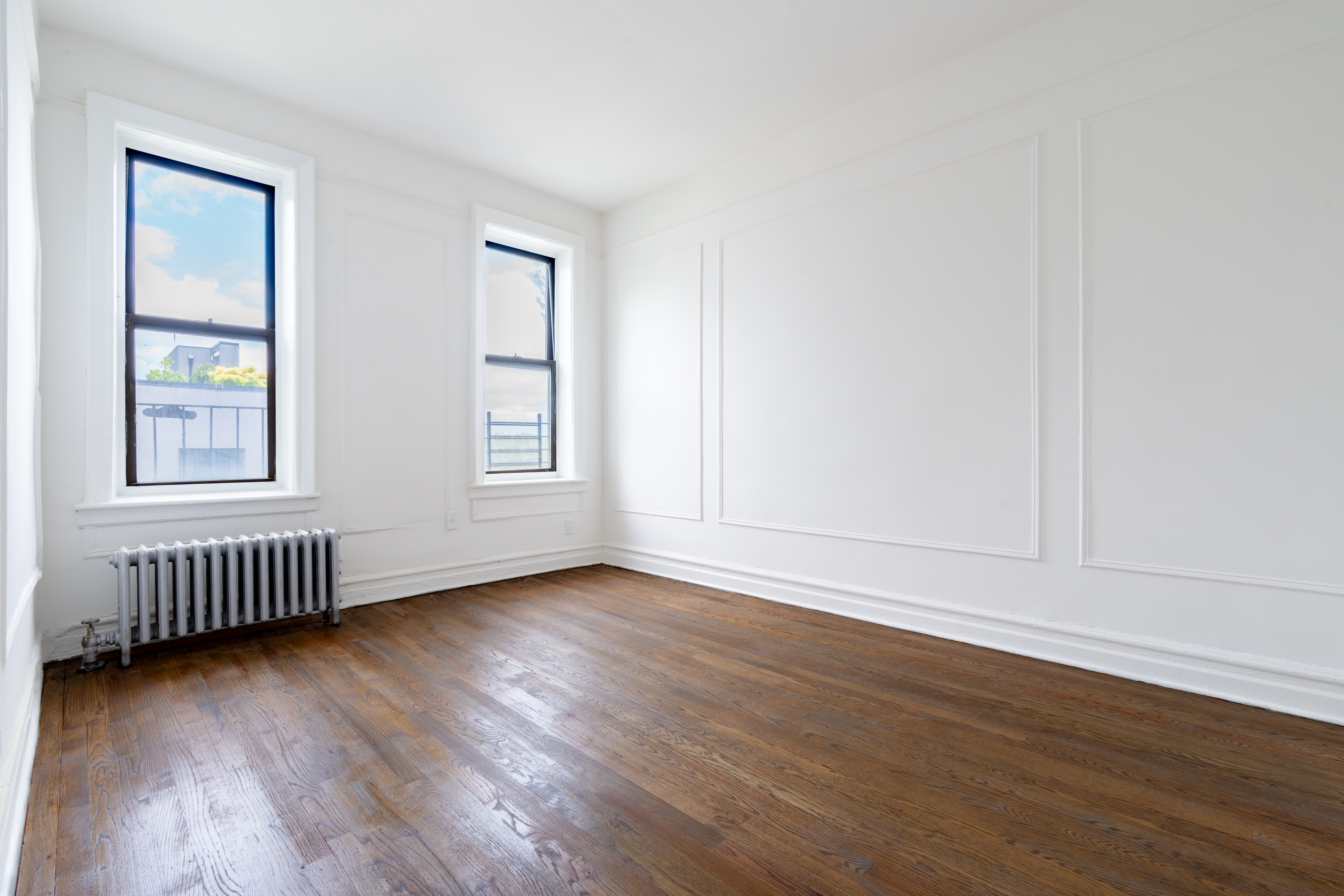1405 Prospect Place, Unit B11 Brooklyn, NY 11213 - Photo 7 of 12 a view of an empty room with wooden floor and windows
