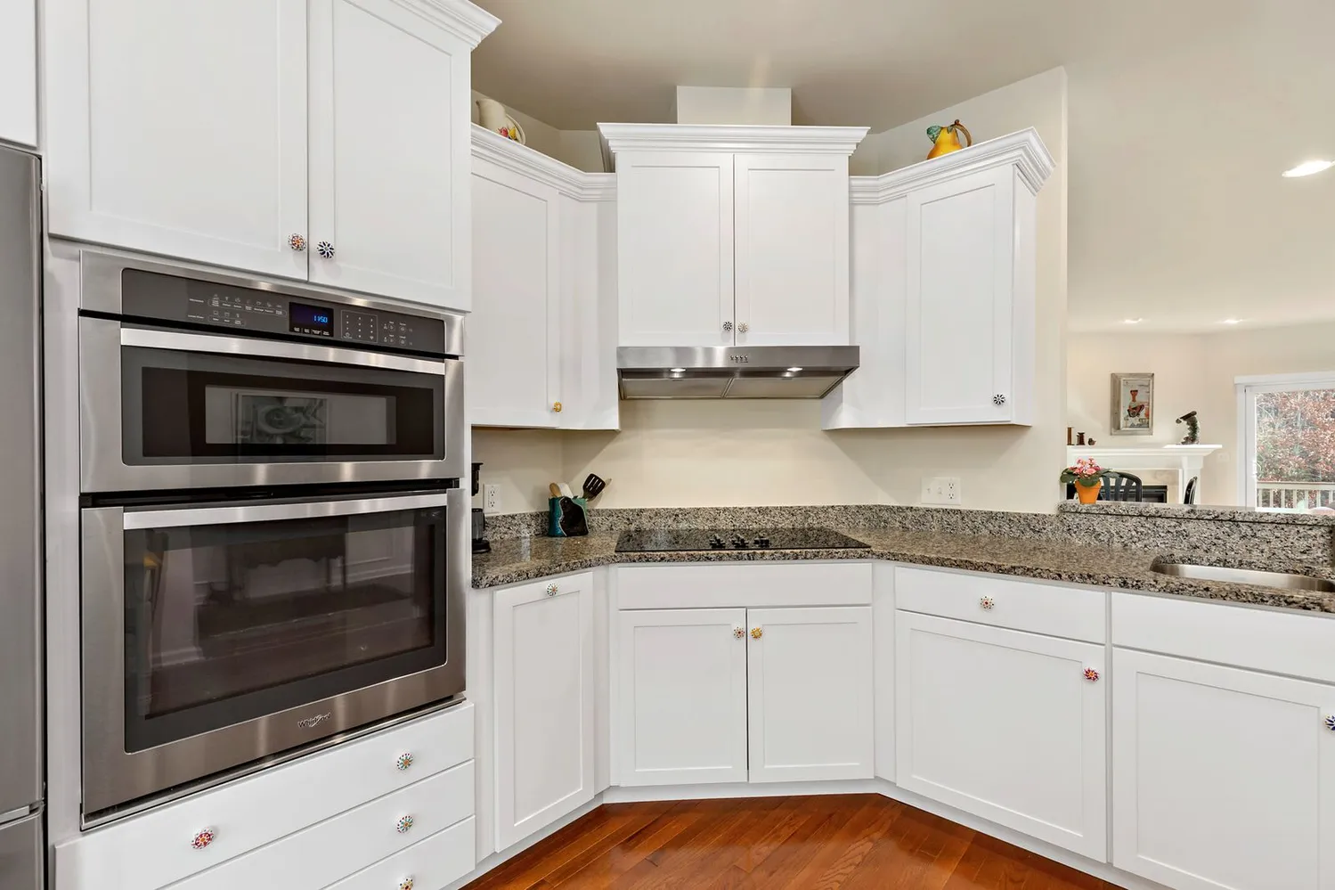 a kitchen with granite countertop white cabinets stainless steel appliances and sink