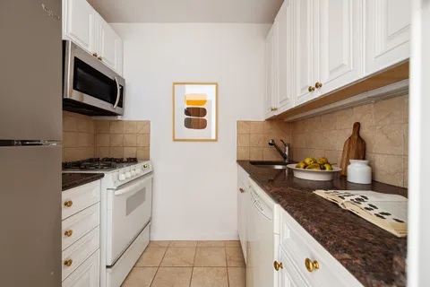 a kitchen with granite countertop a stove and a sink