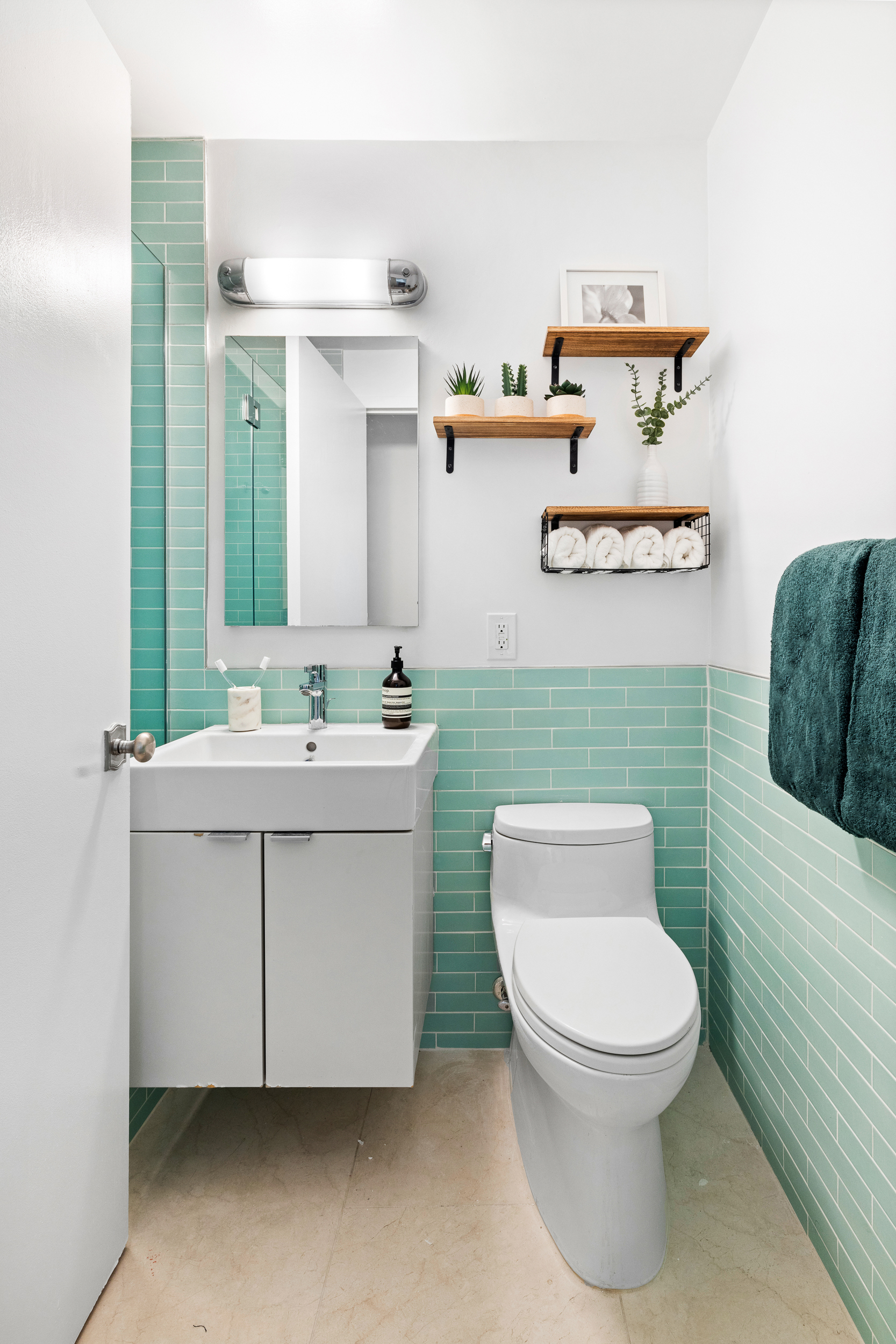 100 West 93rd Street, Unit 11J Manhattan, NY 10025 - Photo 9 of 13 a bathroom with a toilet sink and mirror