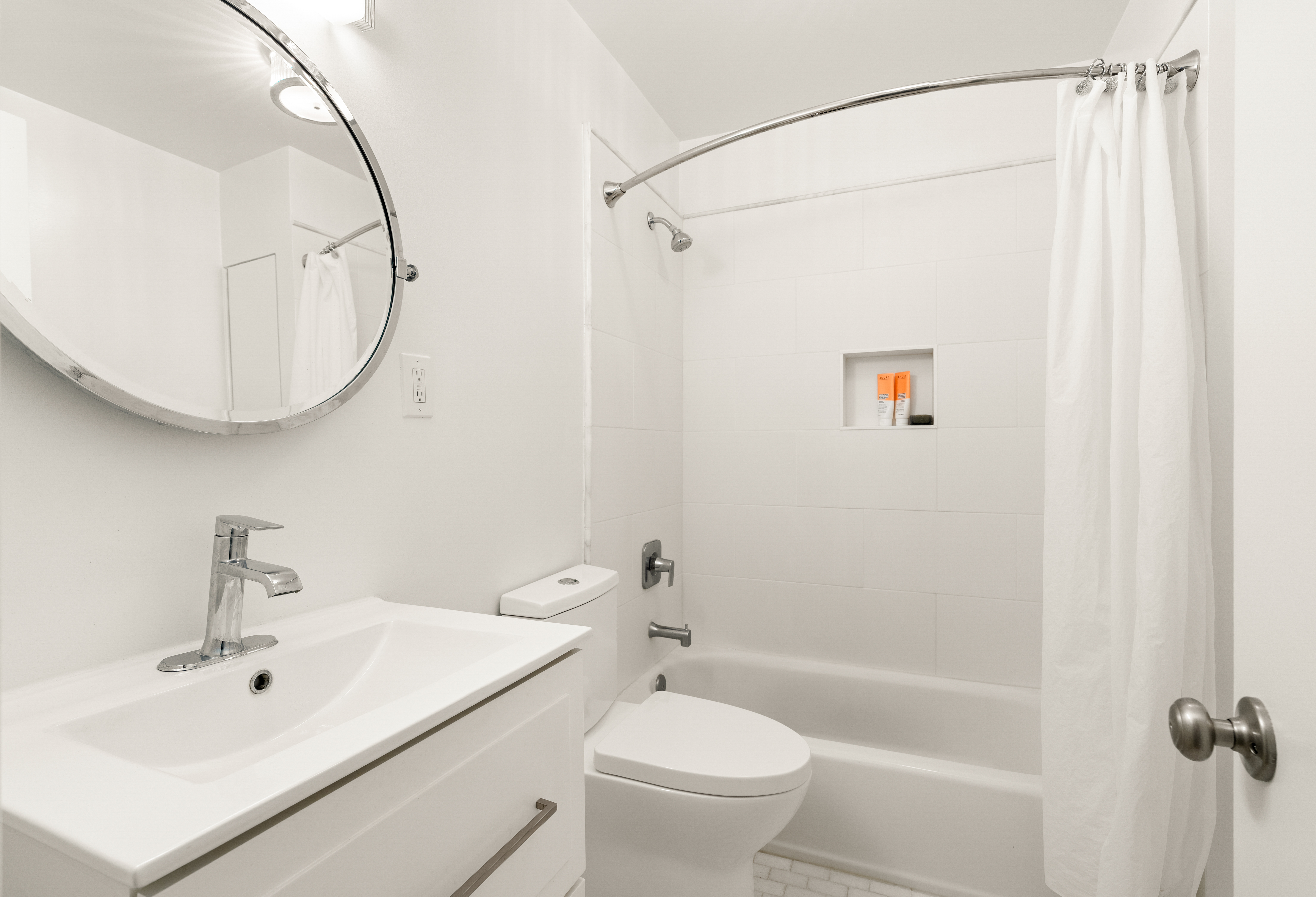 1855 Calvert Street Northwest, Unit 101 Washington, DC 20009 - Photo 8 of 14 a bathroom with a sink a toilet and a mirror