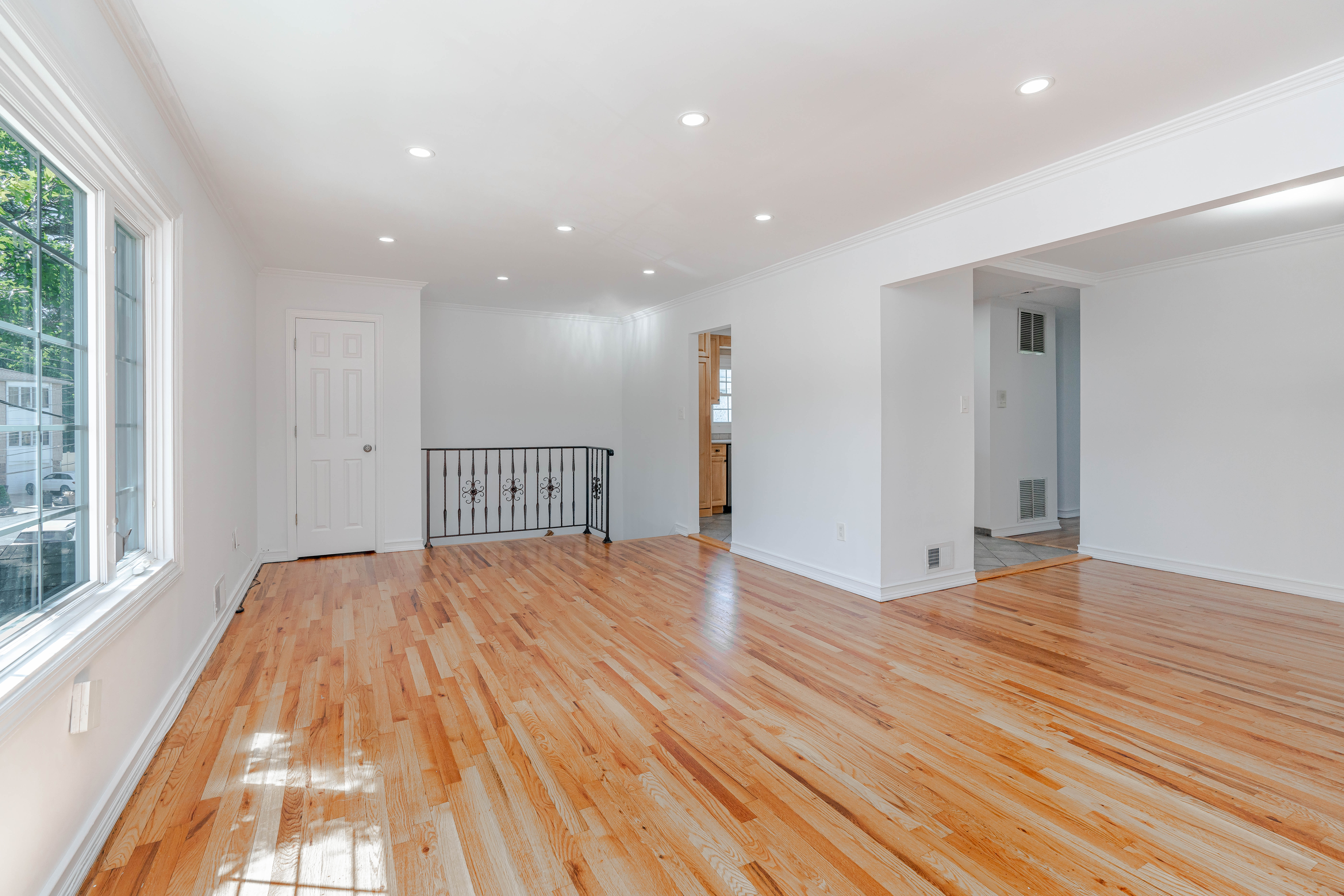 15-80 209th Street, Unit 2 Queens, NY 11360 - Photo 6 of 11 a view of empty room with wooden floor and fan