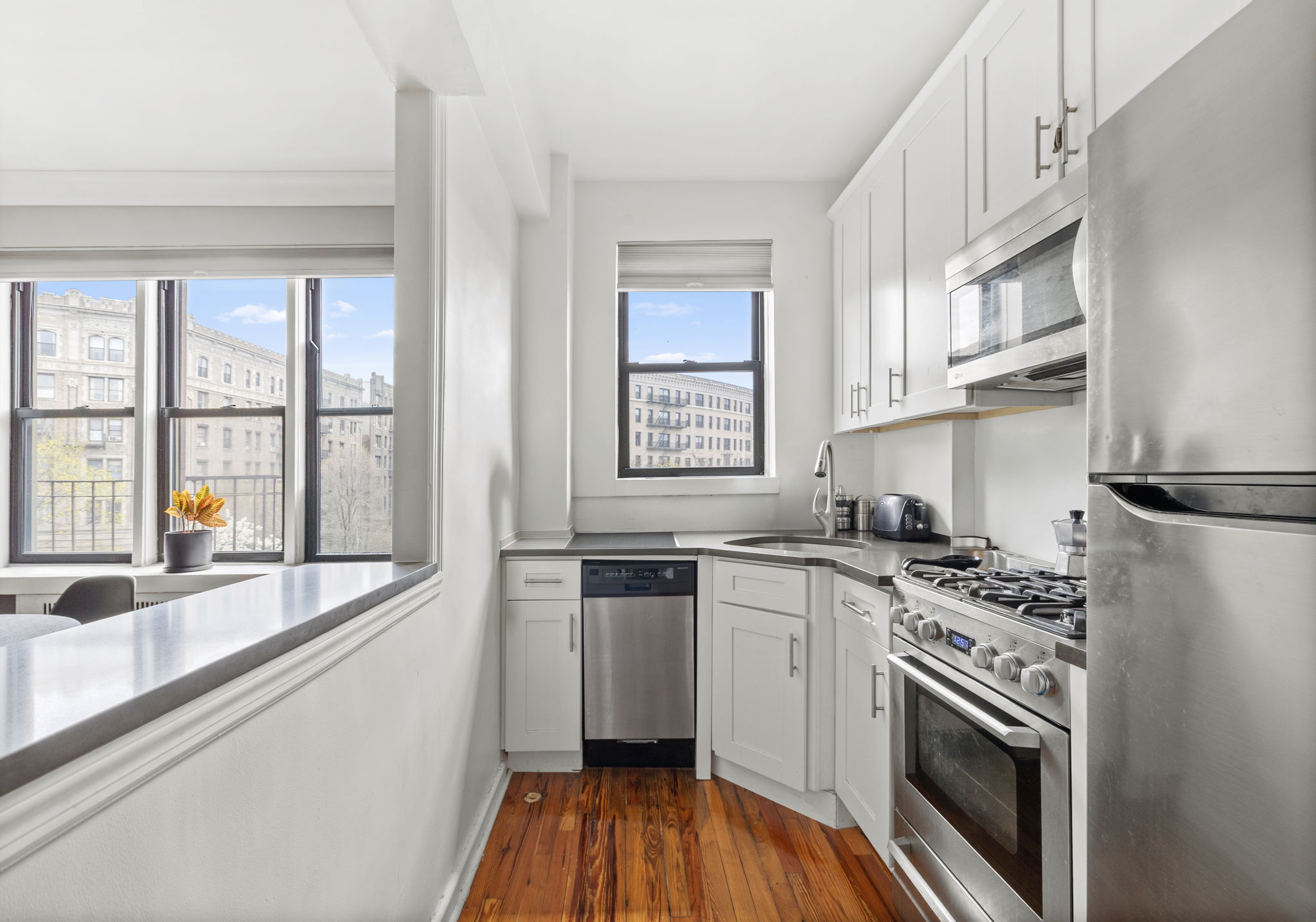 Riverside Dr W, Unit 6H Manhattan, NY 10032 - Photo 2 of 6 a kitchen with stainless steel appliances granite countertop a sink stove and refrigerator