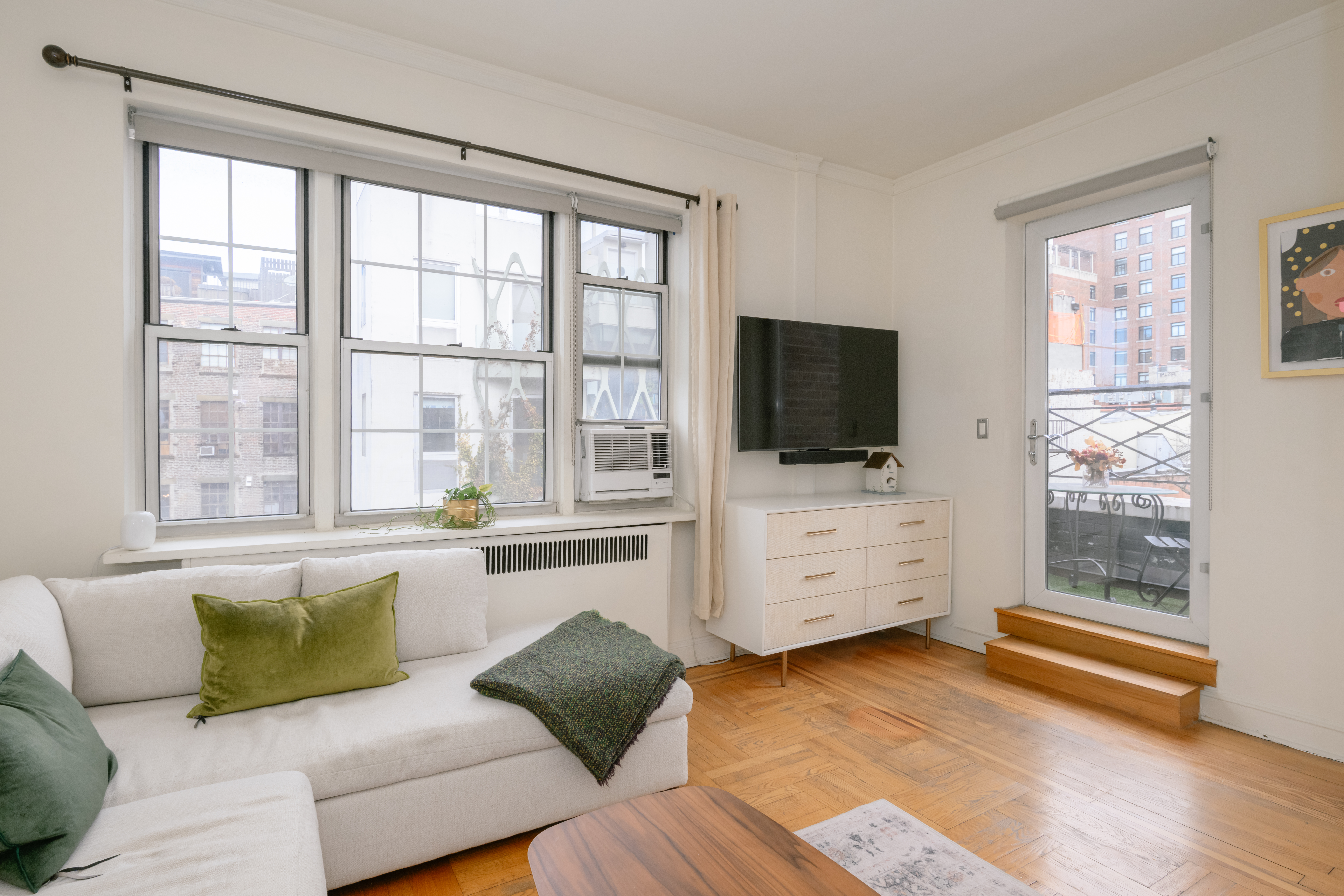 25 Minetta Lane, Unit 6G Manhattan, NY 10012 - Photo 2 of 13 a living room with furniture and flat screen tv