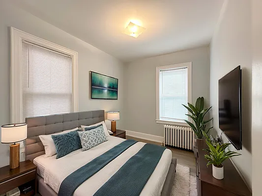 364 97th Street, Unit 2 Brooklyn, NY 11209 - Photo 5 of 8 a bedroom with a bed and a potted plant