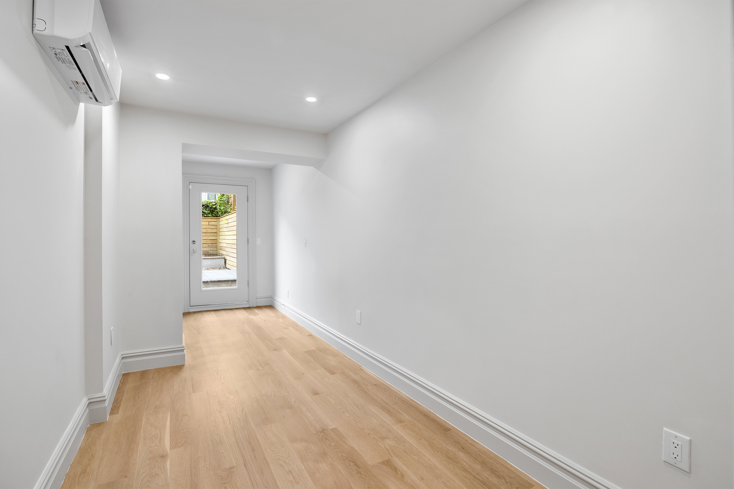 306 Halsey Street Brooklyn, NY 11216 - Photo 8 of 10 a view of an empty room with a window