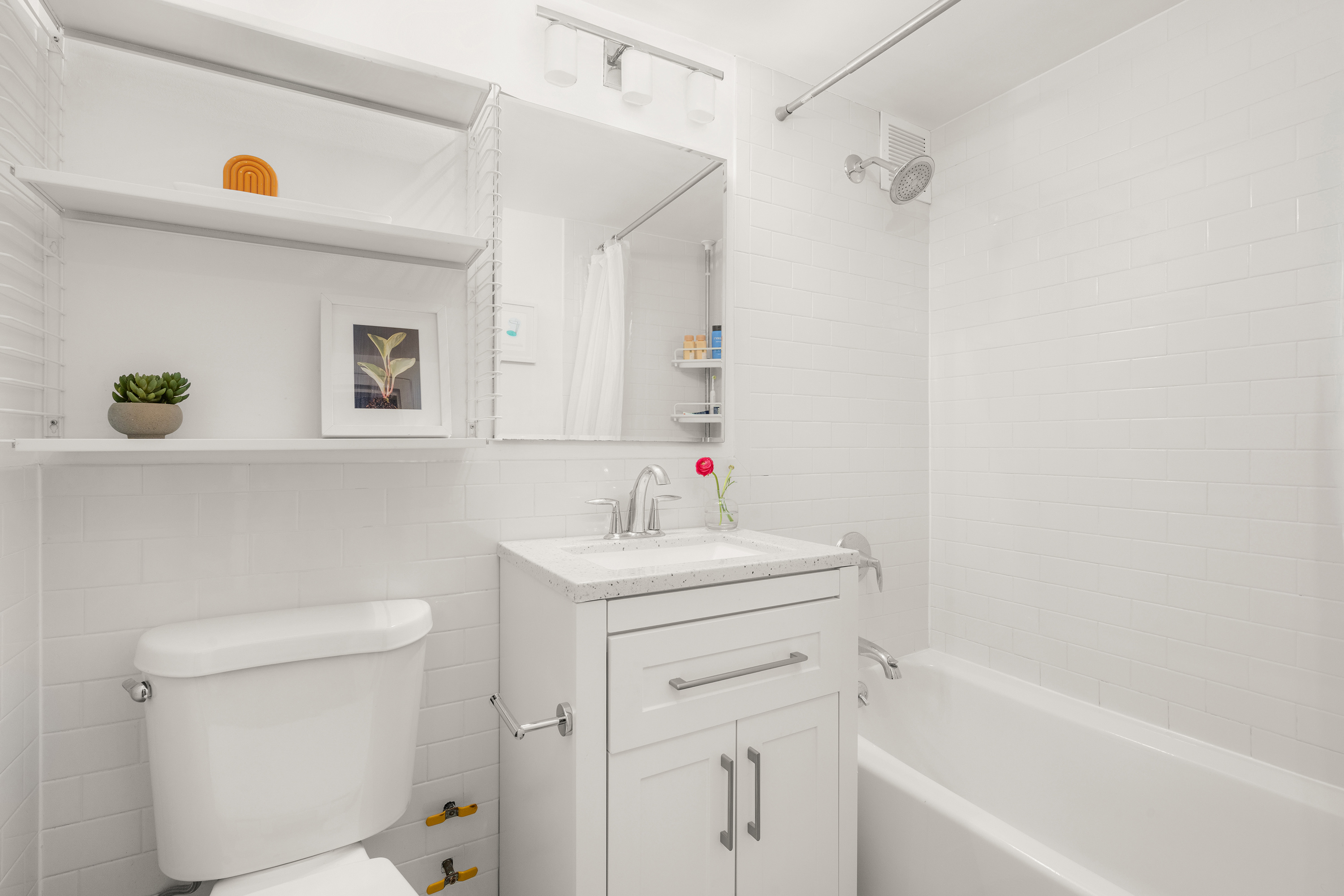 361 Clinton Avenue, Unit 7D Brooklyn, NY 11238 - Photo 7 of 10 a bathroom with a sink a toilet and shower