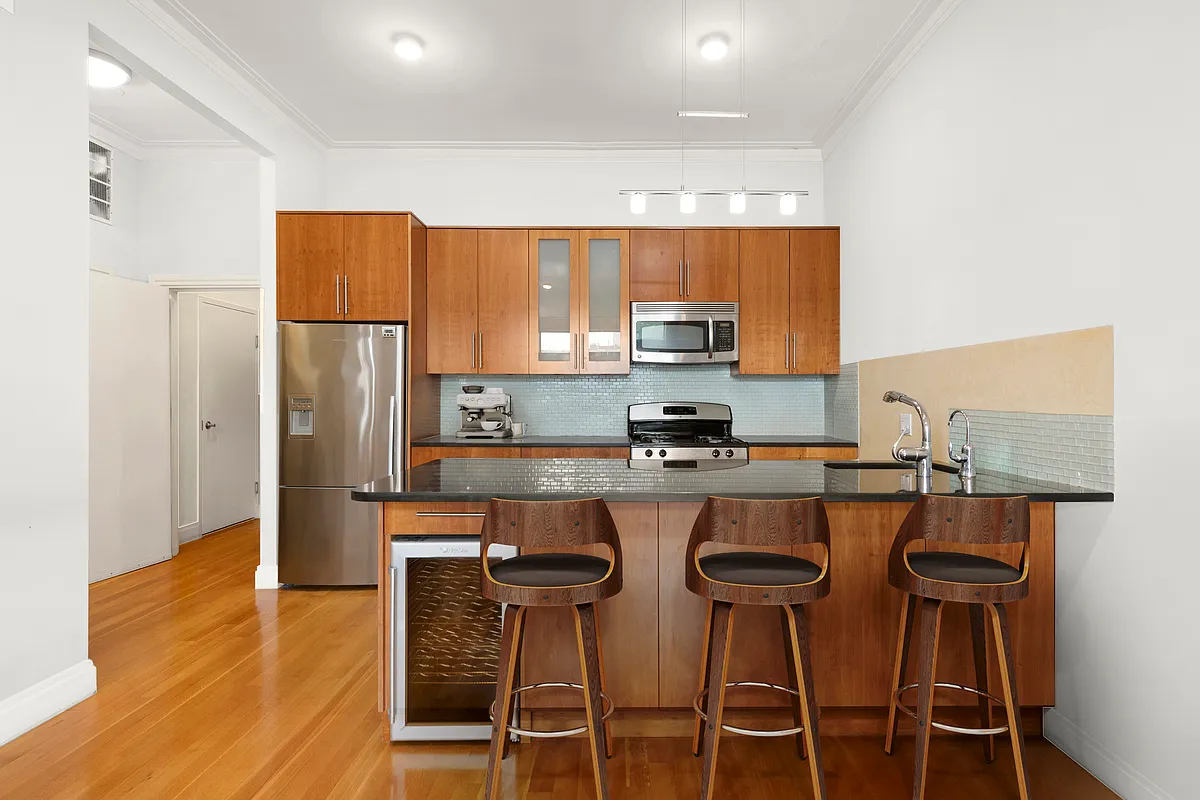 206 Kent Street, Unit 6 Brooklyn, NY 11222 - Photo 5 of 9 a kitchen with stainless steel appliances a stove a refrigerator and cabinets